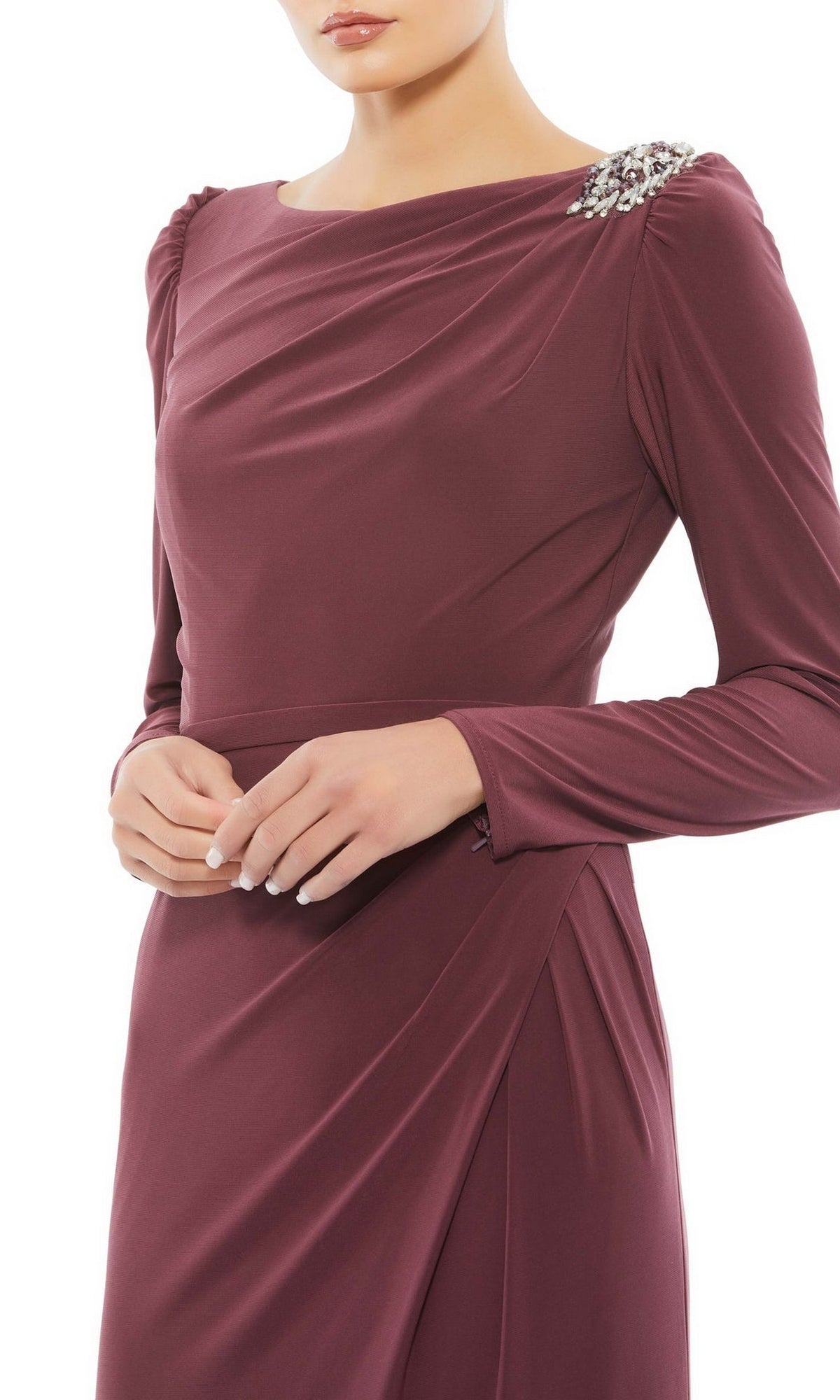 A person wearing the Mac Duggal Long Formal Dress 55695—mauve, long-sleeved, fitted, with gathered fabric and an elegant shoulder embellishment—stands with hands clasped at the waist.