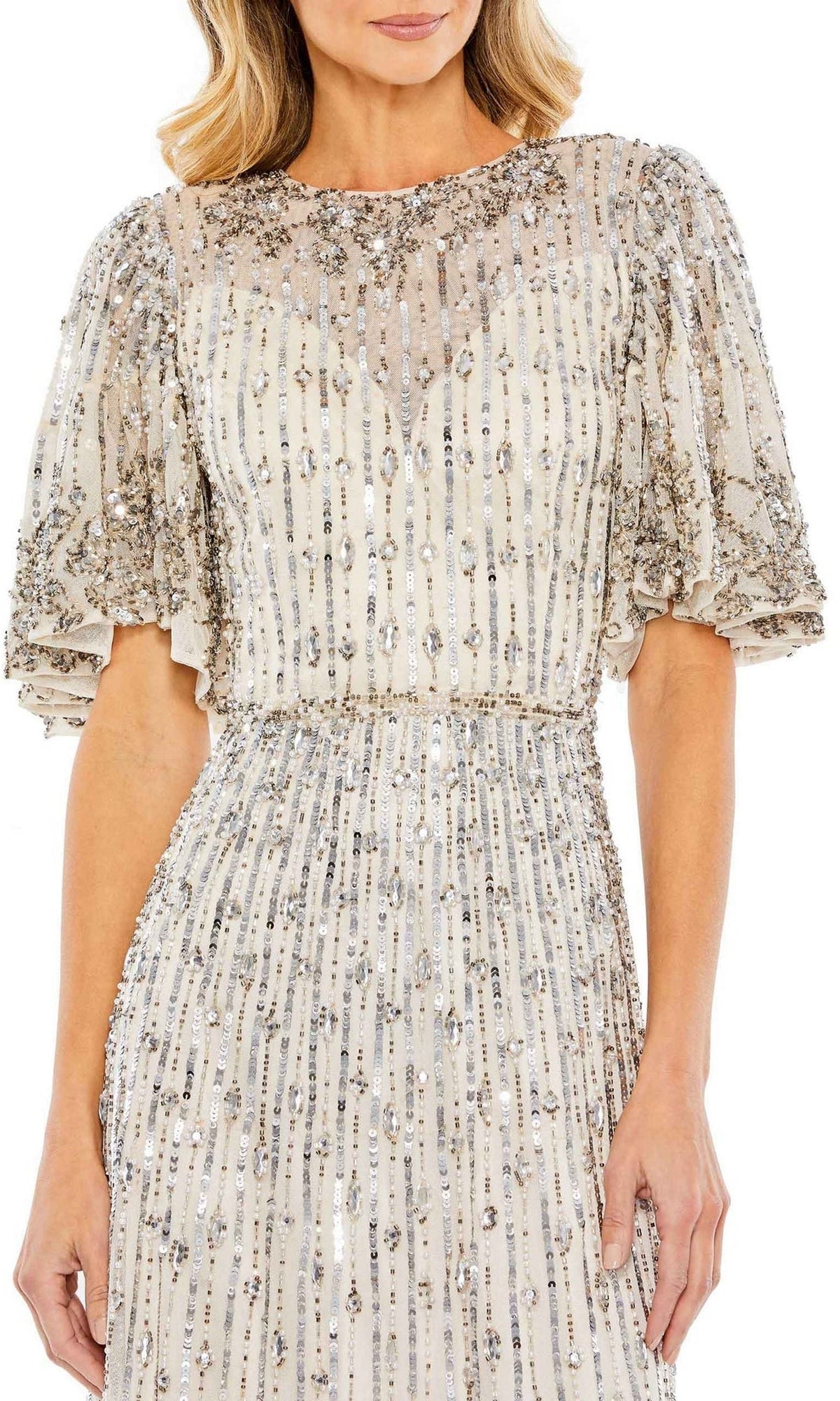 A woman wears the Mac Duggal 5579 Beaded Midi Semi-Formal Dress, featuring short sleeves, silver sequin embellishments, a fitted waist, and sheer overlay—a modest choice for special occasions.