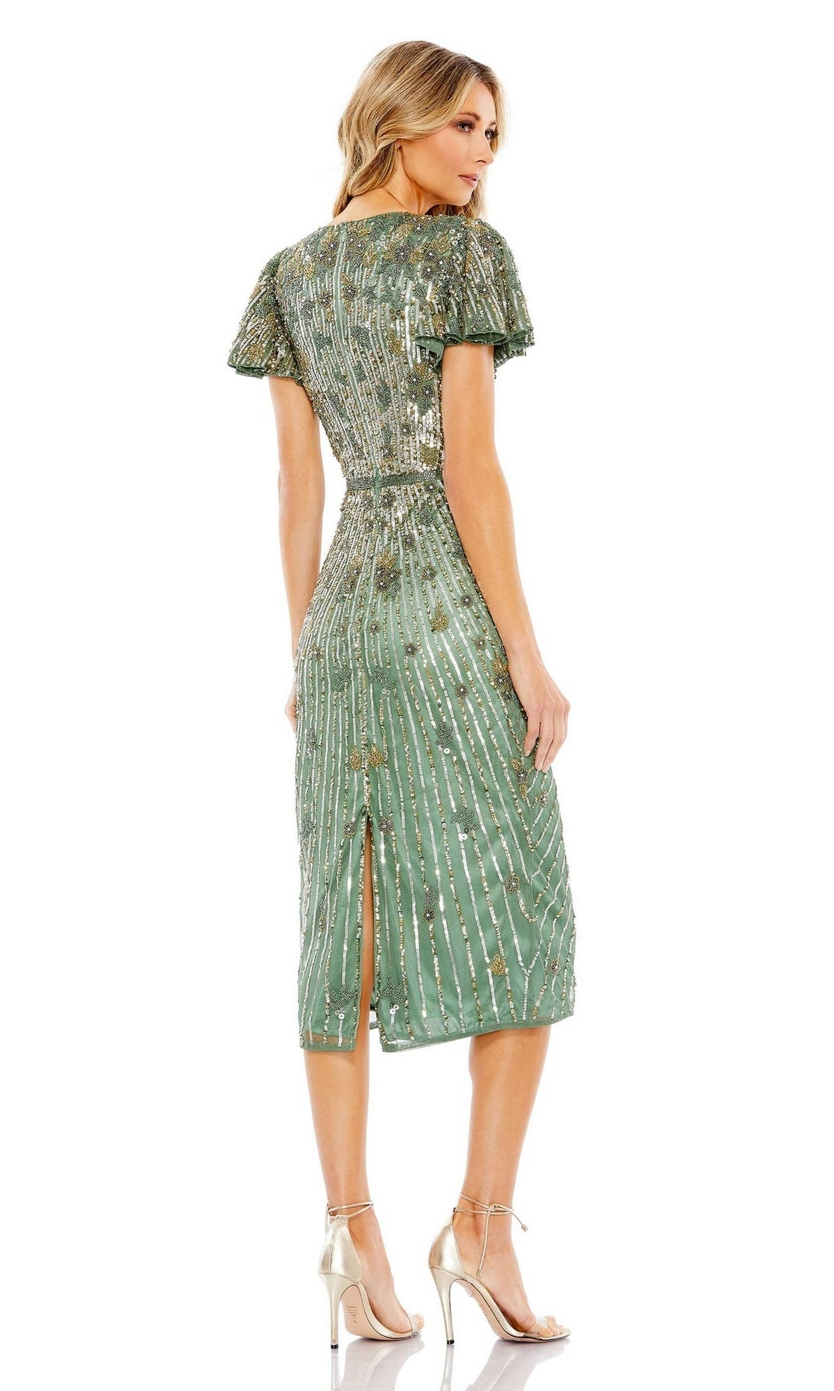 Woman facing away in the Midi Sage Green Semi-Formal Dress: Mac Duggal 5582—a beaded, knee-length midi with short sleeves, back slit, and strappy high-heeled sandals.