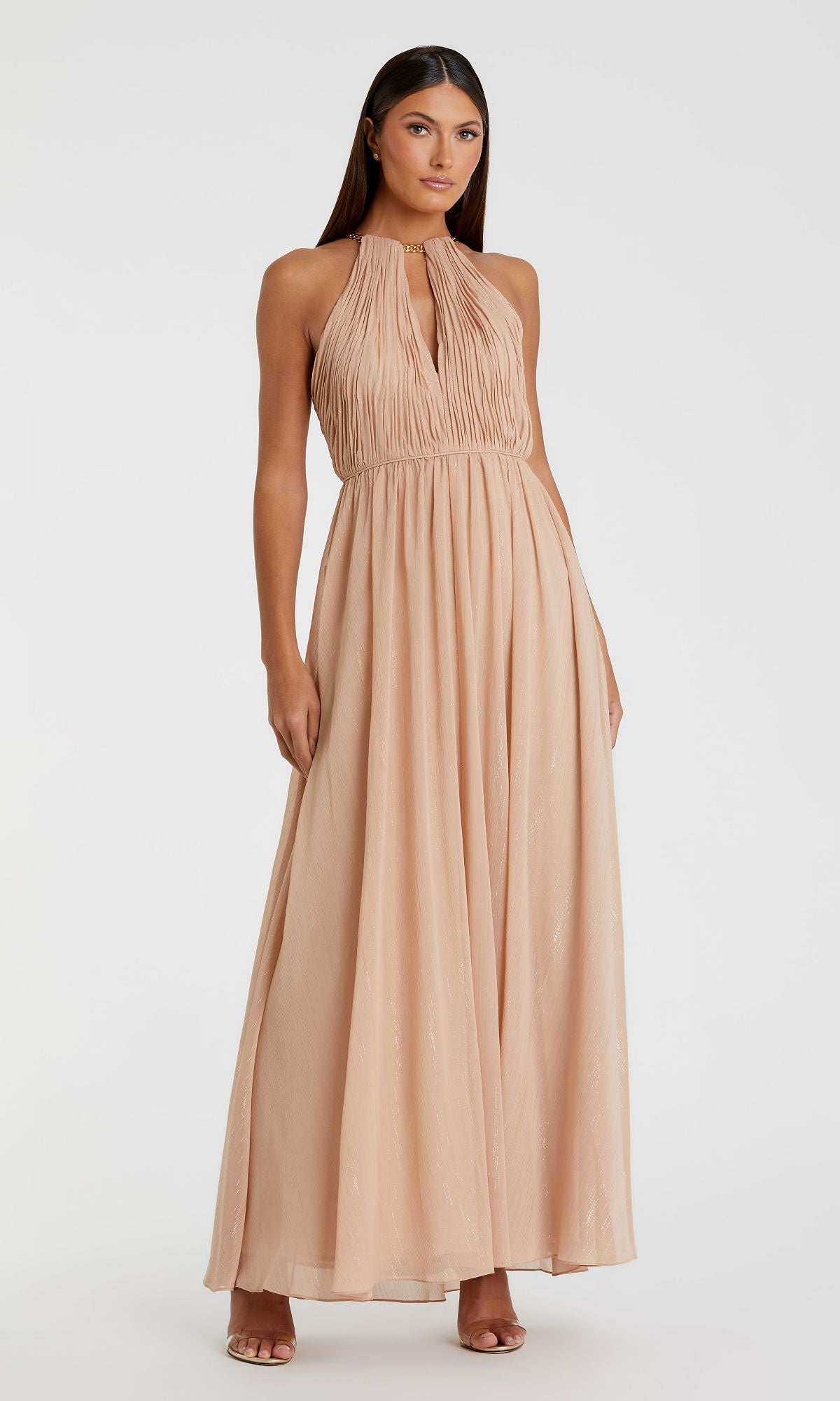 A woman wearing the Mac Duggal 55822 High-Neck Long Nude Formal Dress, an A-line style with a gathered bodice and flowing skirt, stands against a plain white background.