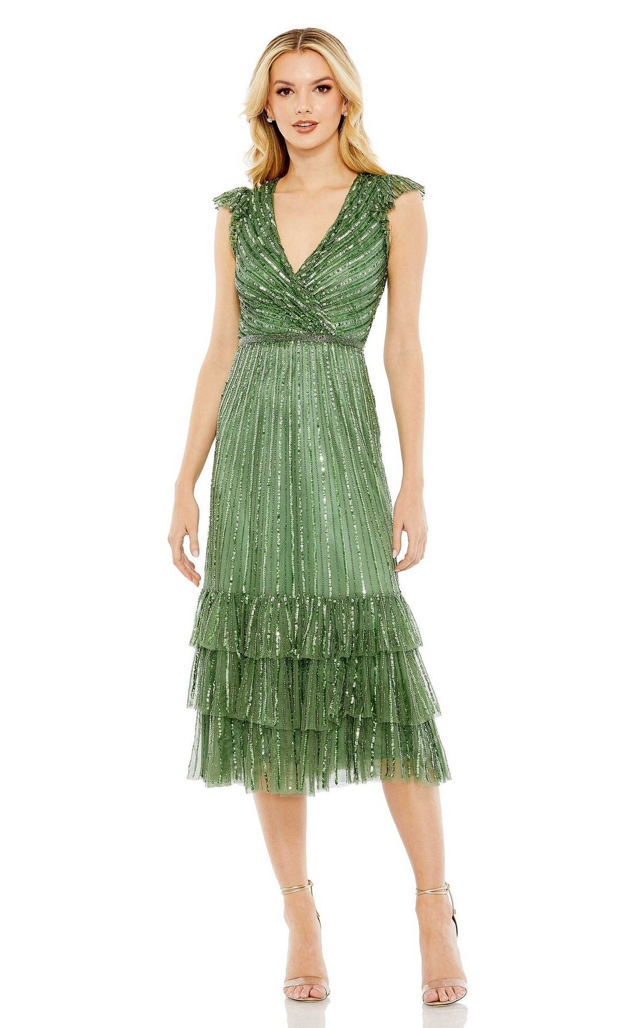 A woman wears the Mac Duggal 5585 Cap-Sleeve Midi Party Dress, featuring a pleated design with sequin details and a tiered ruffle hem, styled with strappy high-heeled sandals.