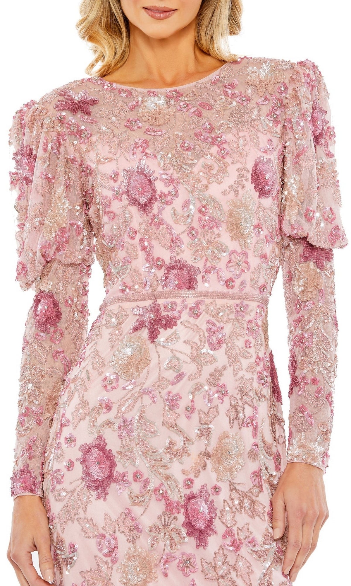 Woman wearing the Mac Duggal Short Semi-Formal Dress 5590, featuring light pink long sleeves, puffed shoulders, a beaded waistband, and pink floral sequin embroidery.