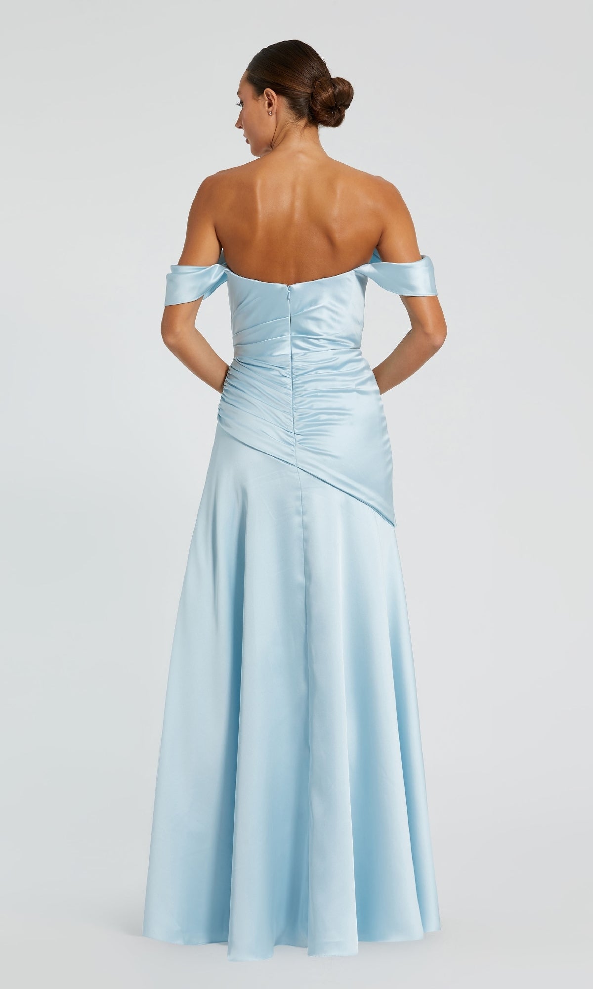 Woman standing with her back to the camera, wearing the Mac Duggal 56037 light blue off-the-shoulder prom dress, featuring a fitted bodice and flared floor-length skirt—a stunning choice for any special occasion.