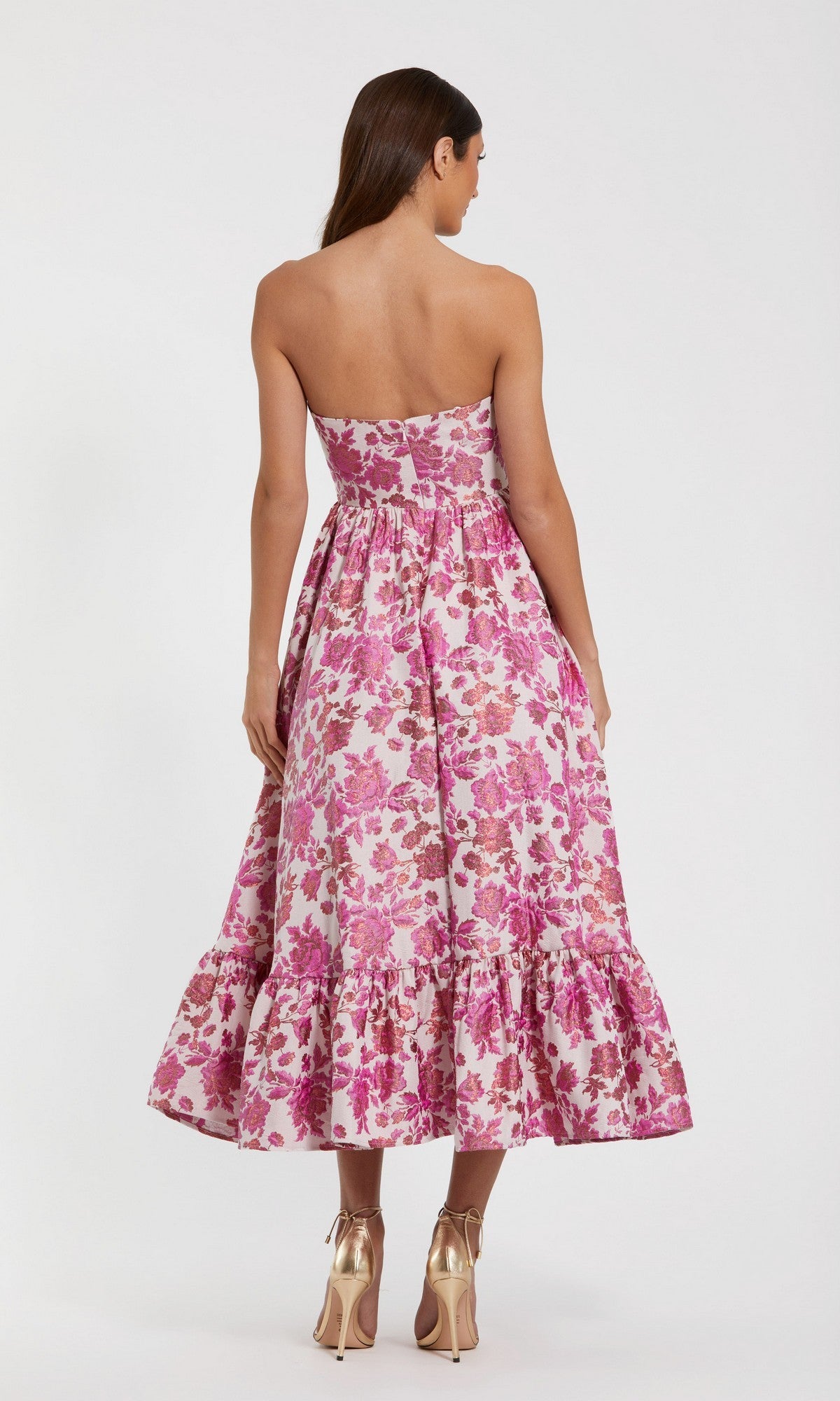 Woman wearing the Mac Duggal 56092 Midi Floral Wedding Guest Dress, strapless with a ruffled hem, standing and facing away—an elegant choice for any wedding guest.