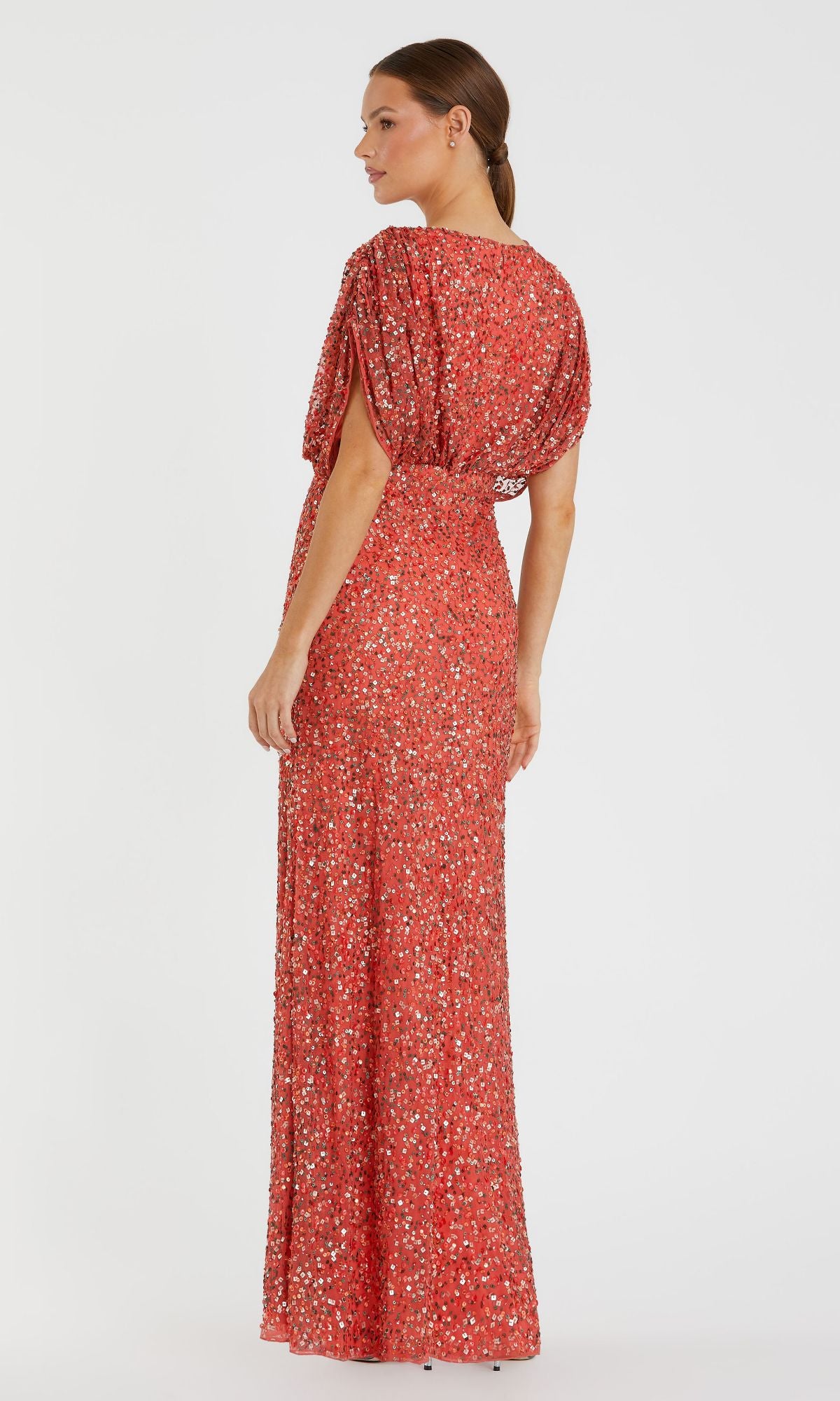 A woman stands facing away against a white background, wearing the Mac Duggal 5640 Short Sleeve Long Sequin Formal Dress in red.