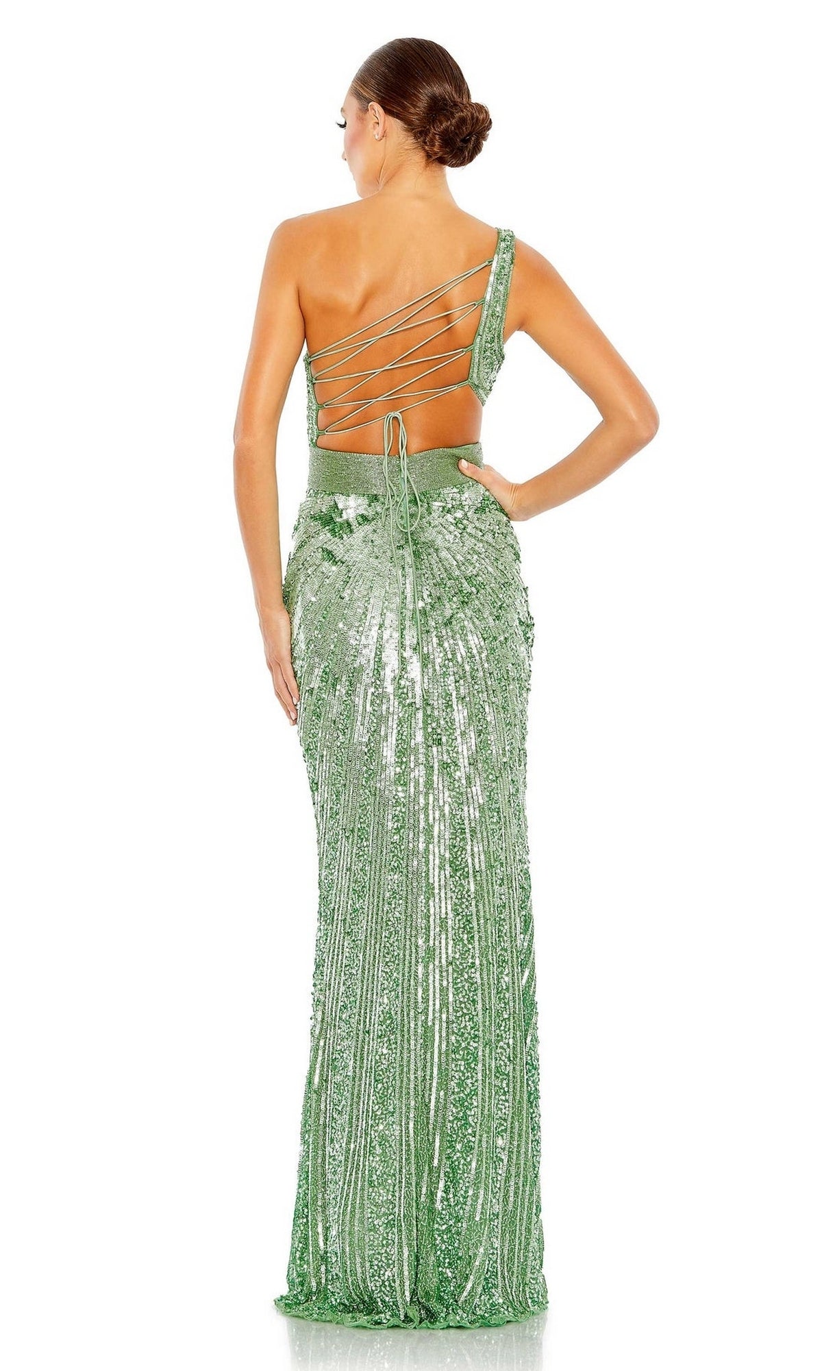 A woman faces away in the Mac Duggal 5687 One-Shoulder Sequin Formal Dress, featuring a floor-length fitted silhouette and lace-up back. Her low bun hairstyle beautifully complements the gown’s elegant design.