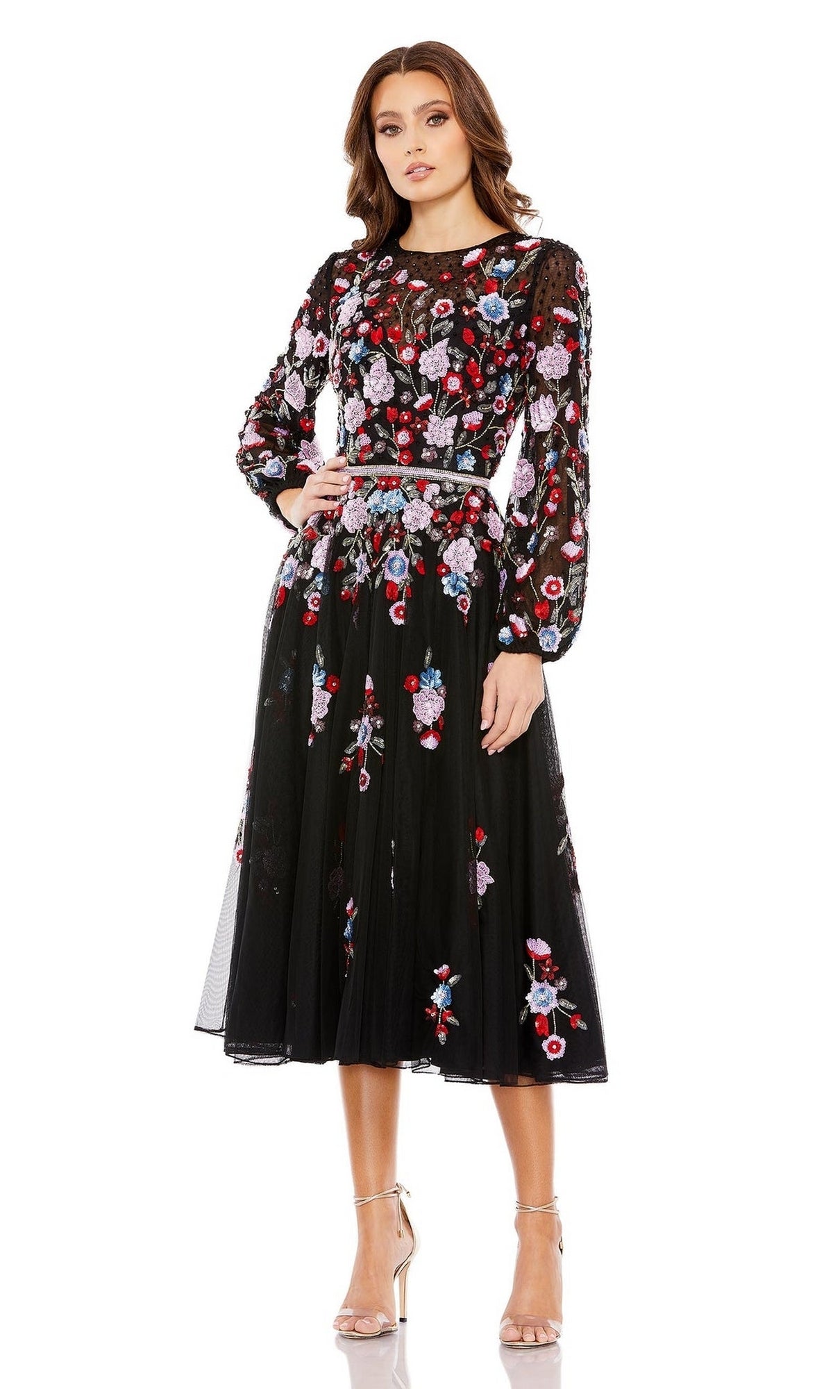 Woman models the Short Semi-Formal Dress 5712 by Mac Duggal—an effortlessly chic black long sleeve dress featuring colorful floral embroidery, perfect for a stylish semi-formal look.