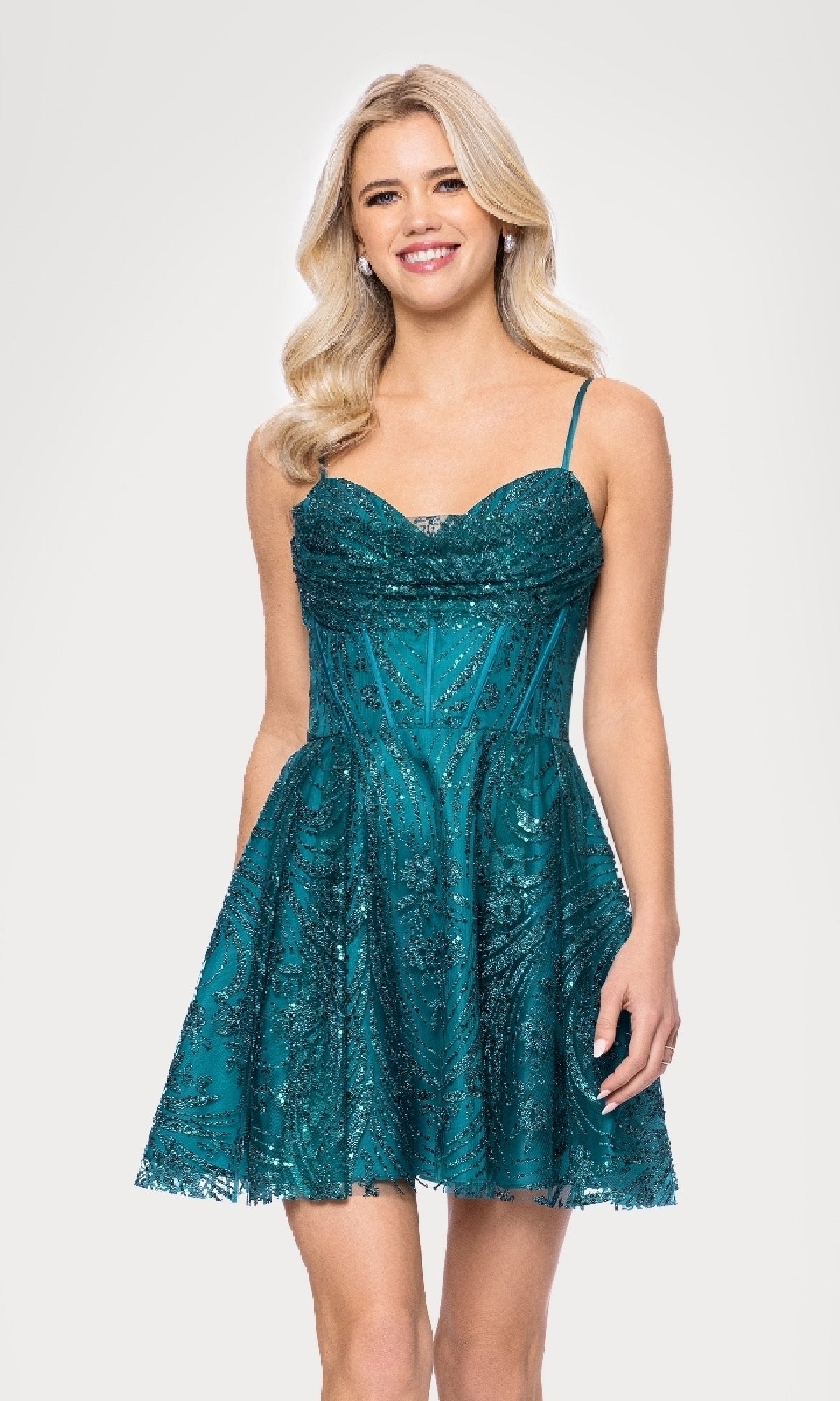 A woman with long blonde hair models the Blondie Nites 5713BN cowl-neck short Hoco dress—a sleeveless, sparkly teal junior A-line party dress with thin straps and a flared skirt—against a white background.