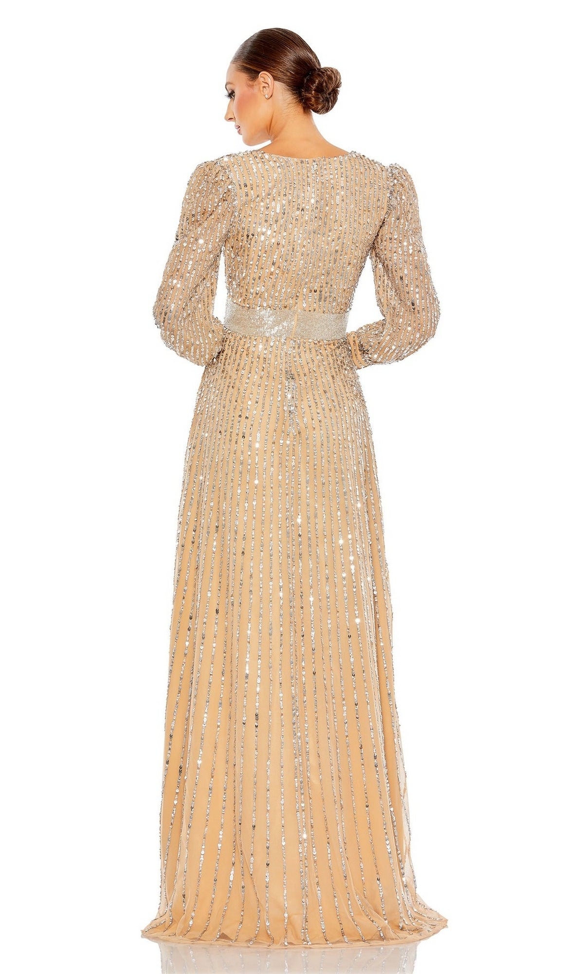 A woman faces away in the Mac Duggal 5720 long sleeve sequin formal dress with silver stripes and a fitted waist. Her low bun enhances the gown’s elegant mother of the bride look.