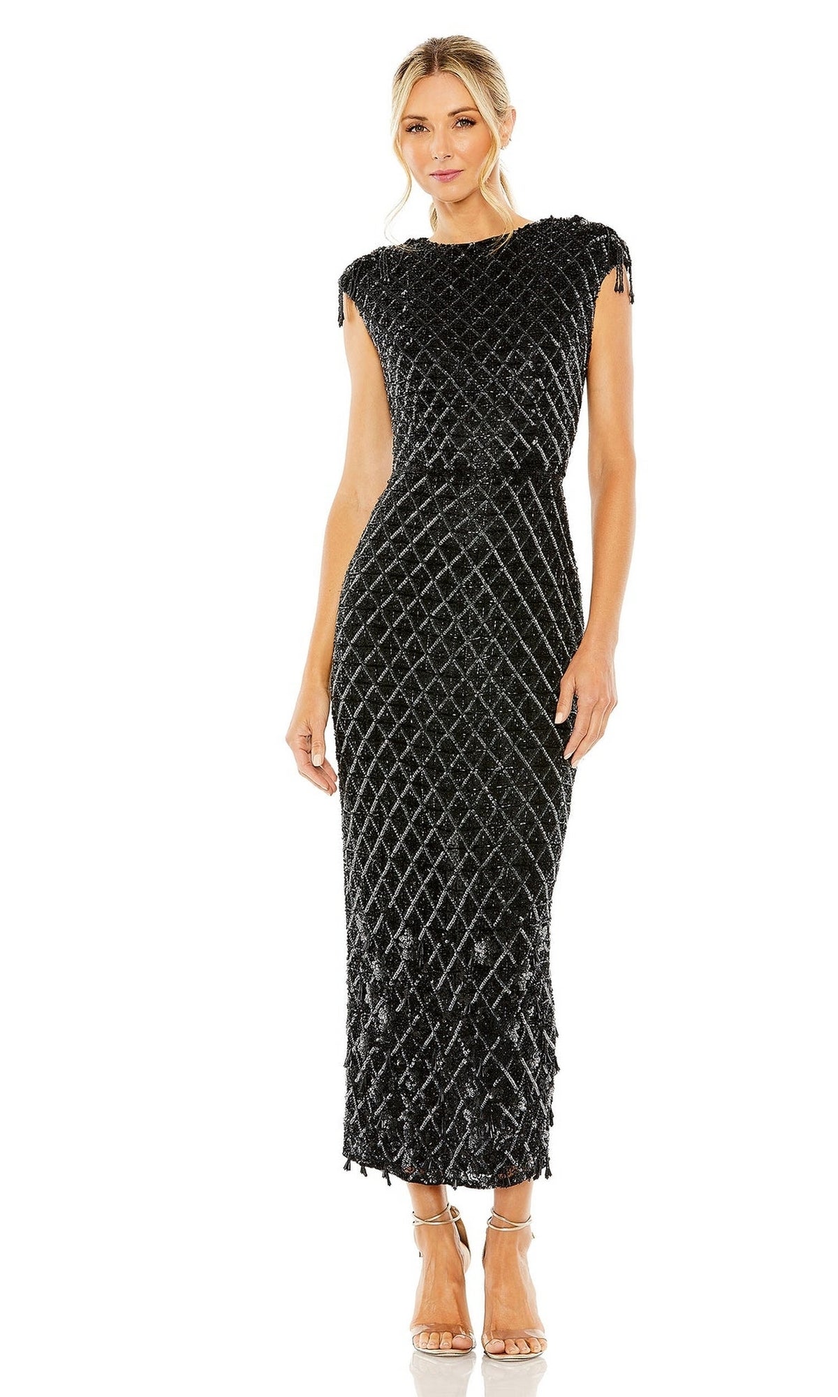 A woman stands wearing the Mac Duggal 5776 Beaded Black Midi Formal Dress with a diamond pattern and textured details, paired with nude heels.