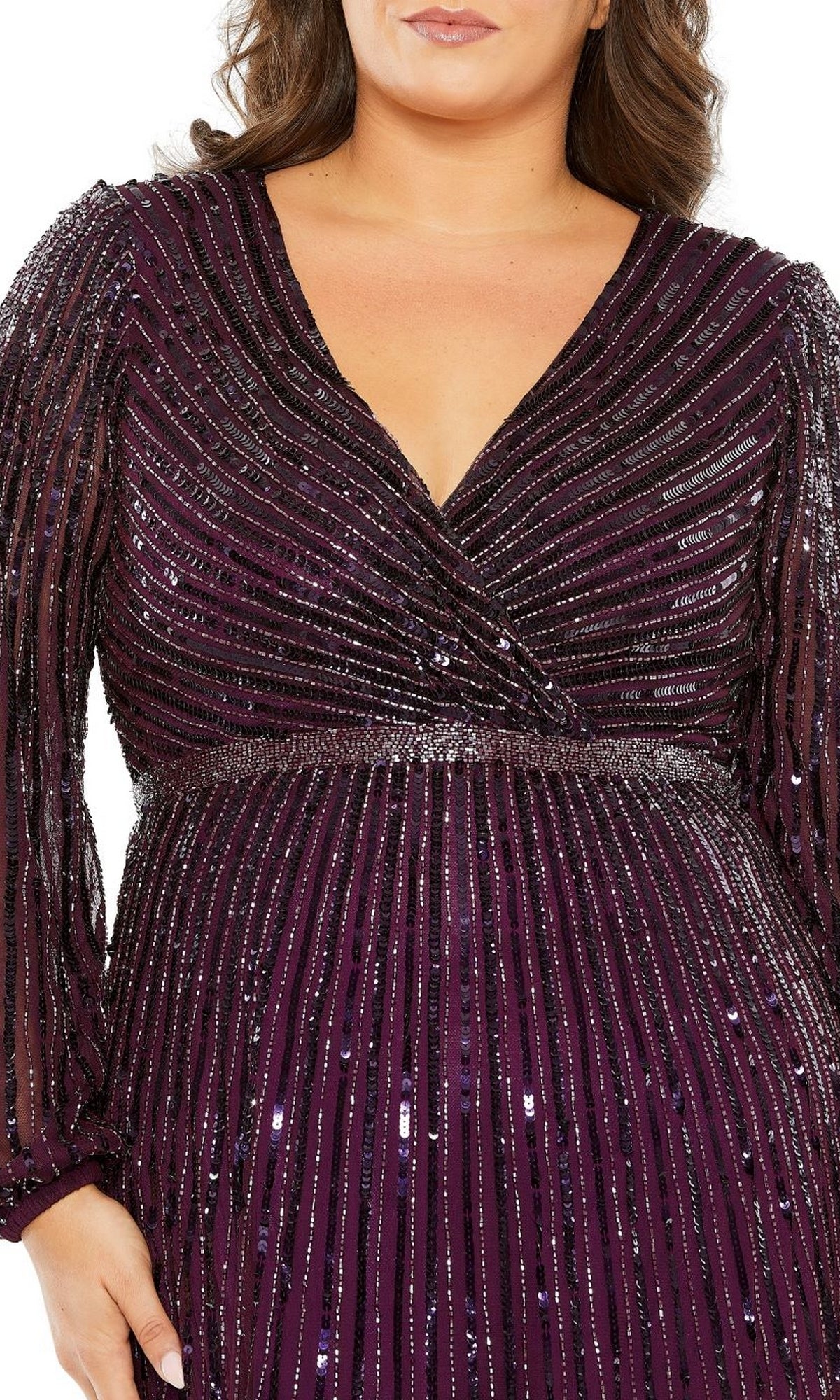 A person wearing the Long Plus-Size Formal Dress 5784 by Mac Duggal, in deep purple, featuring vertical sequined stripes and a flattering V-neckline.