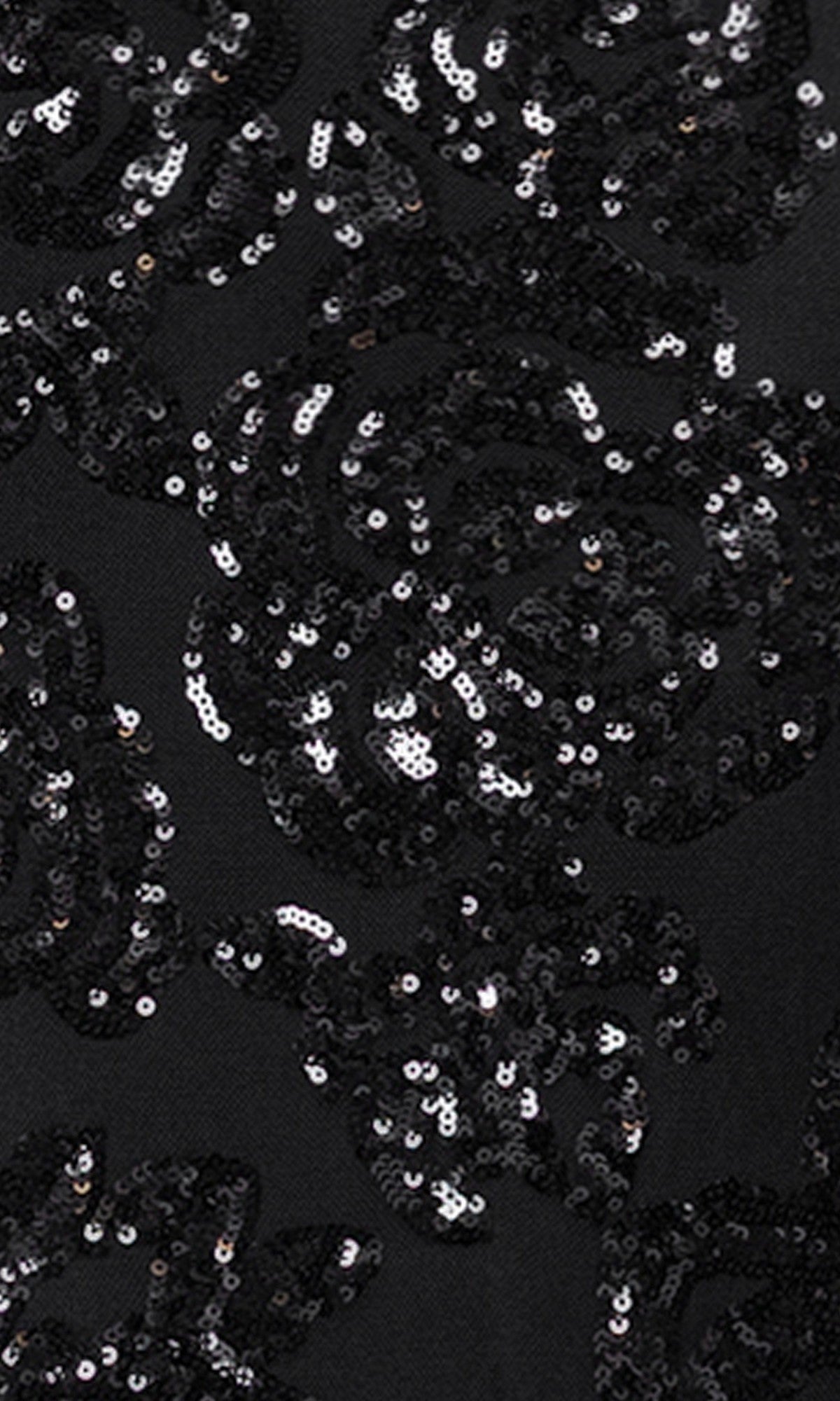 Close-up of black fabric with shiny black sequins in a swirling pattern, featured on the elegant Blondie Nites 5905BN long prom dress.