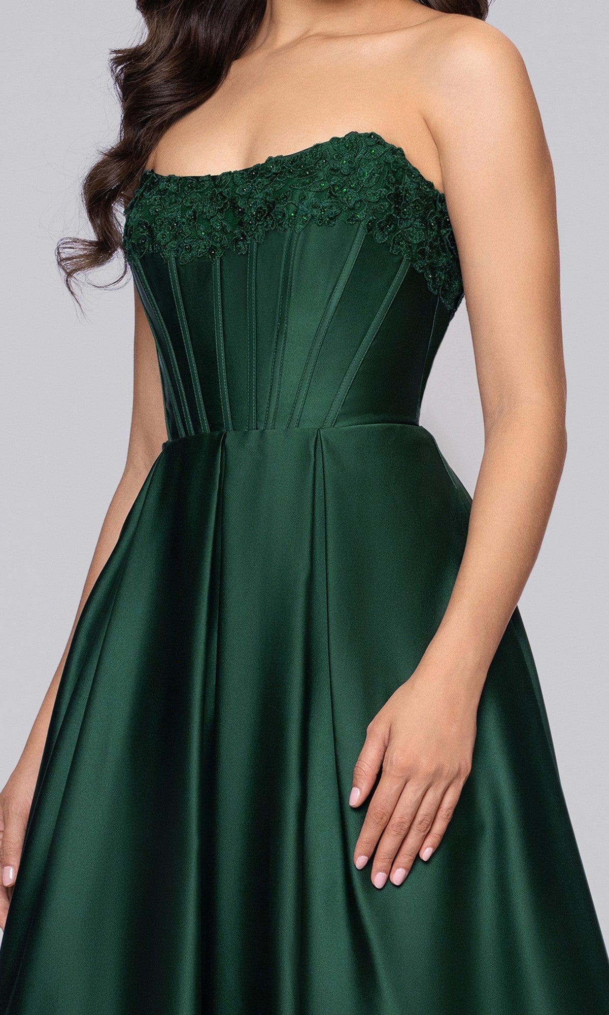 A woman wears the Blondie Nites 5918BN long prom dress in dark green satin with a strapless, floral-embroidered corset bodice, standing against a plain background.