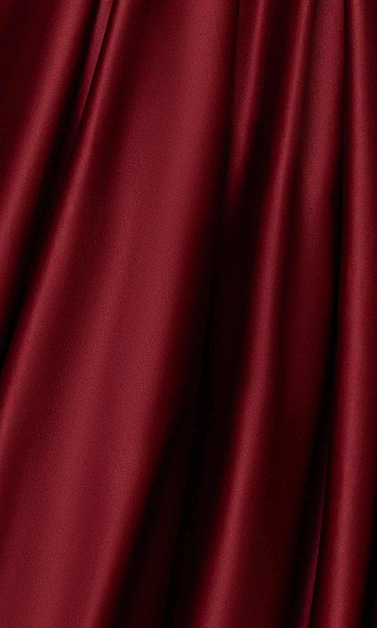 Close-up of smooth, deep red fabric with soft folds, as seen on the Blondie Nites 5918BN long prom dress with its elegant strapless satin design and refined corset bodice.