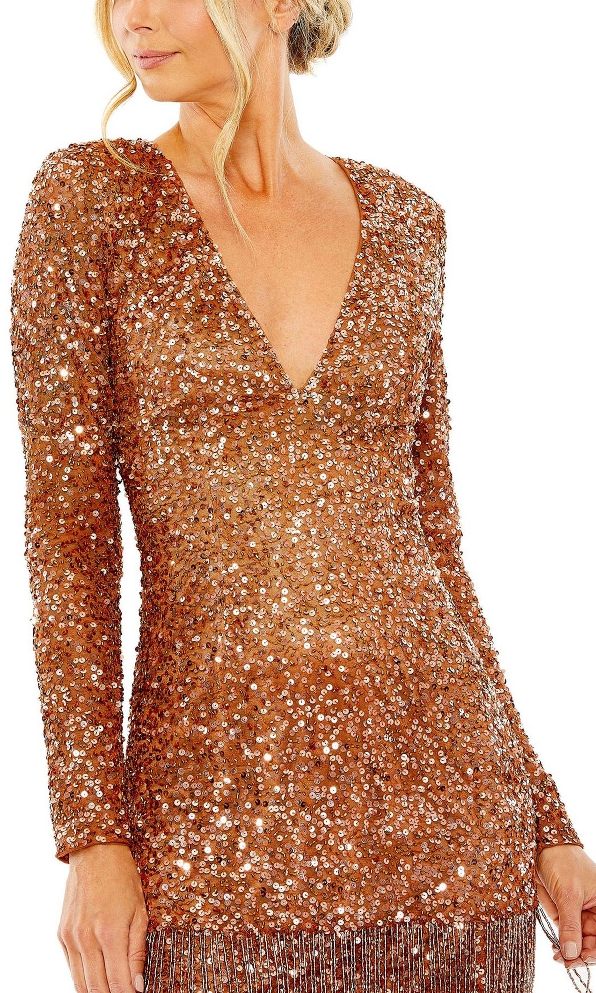A woman wears the Mac Duggal 5928 Short Beaded Copper Hoco Dress, featuring long sleeves, a V-neckline, copper sequins, and fringe at the hem.