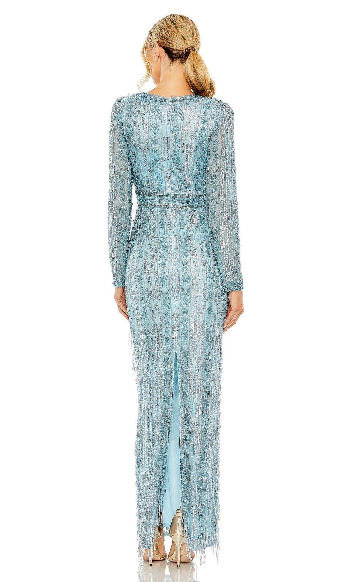 A woman with blonde hair in a low ponytail is seen from behind wearing the Long Formal Dress 5981 by Mac Duggal, a light blue beaded fringe gown with long sleeves, back slit, and striking fringe accents.