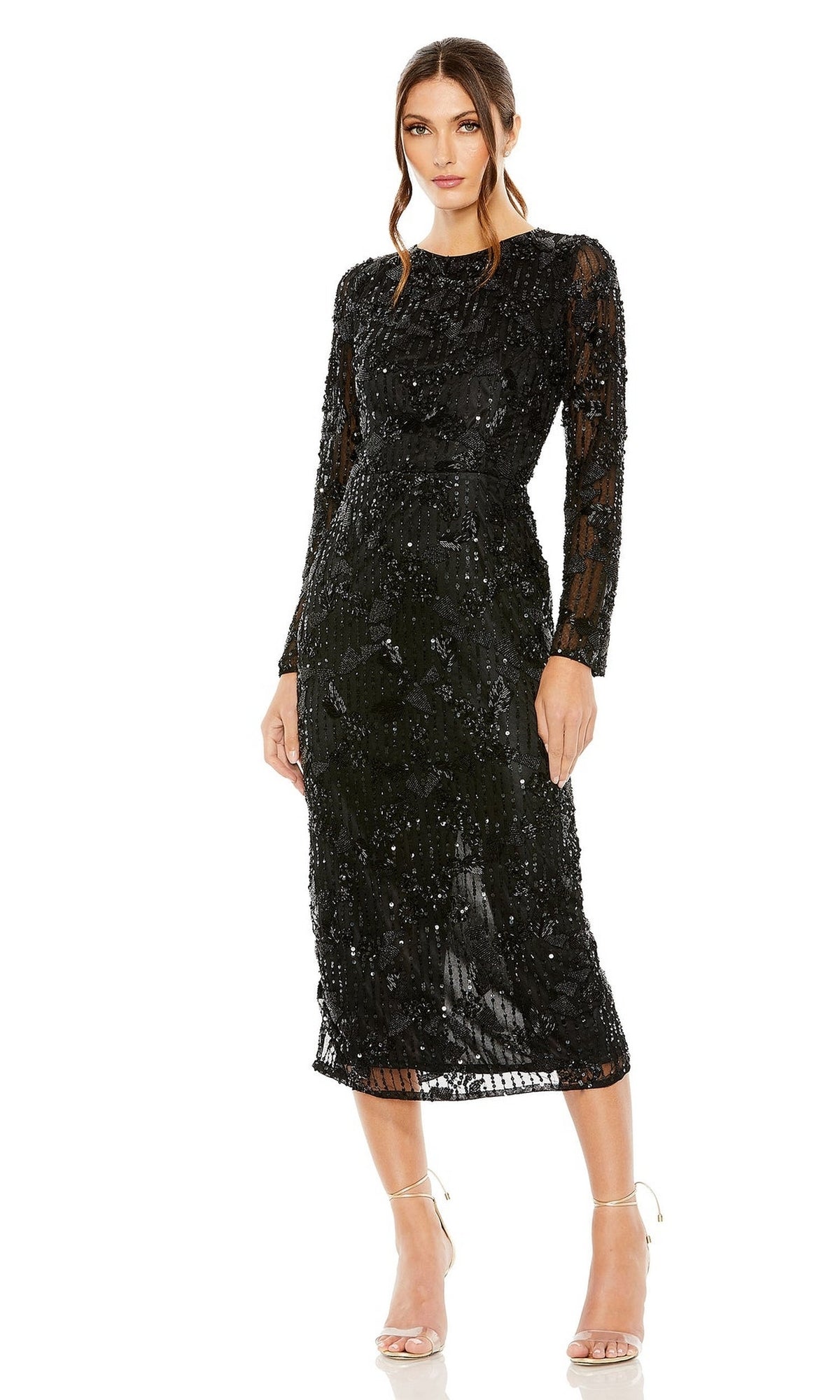 Woman wearing the Mac Duggal 5988 long sleeve wedding guest dress—black midi with beaded sequins, sheer details, and paired with strappy heels—a perfect cocktail choice for any occasion.