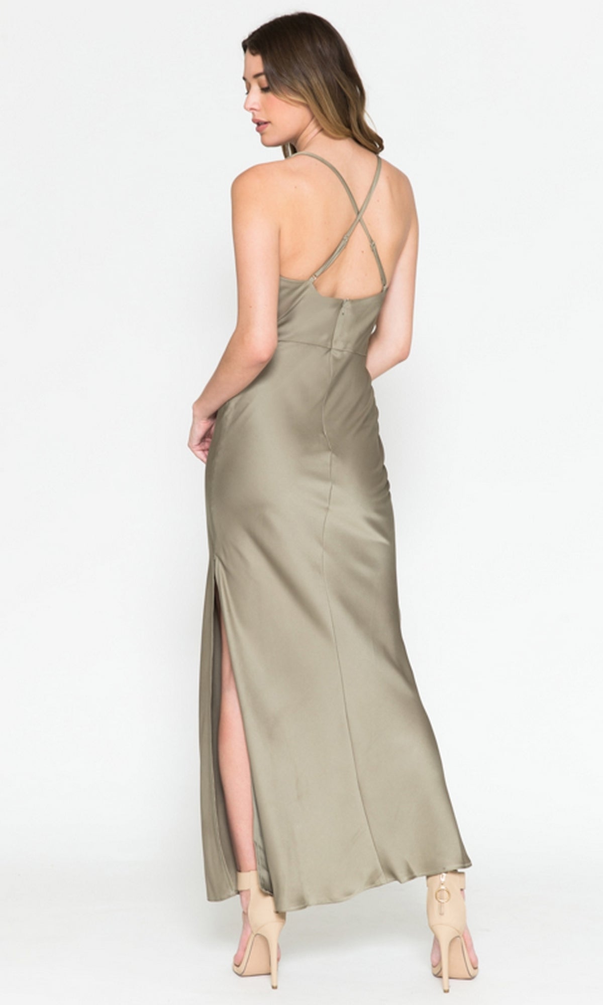 Woman wearing the Cowl-Neck Simple Tea-Length Satin Dress 6115 in olive green, featuring crisscross straps and a high slit, poses with her back to the camera against a plain white background.