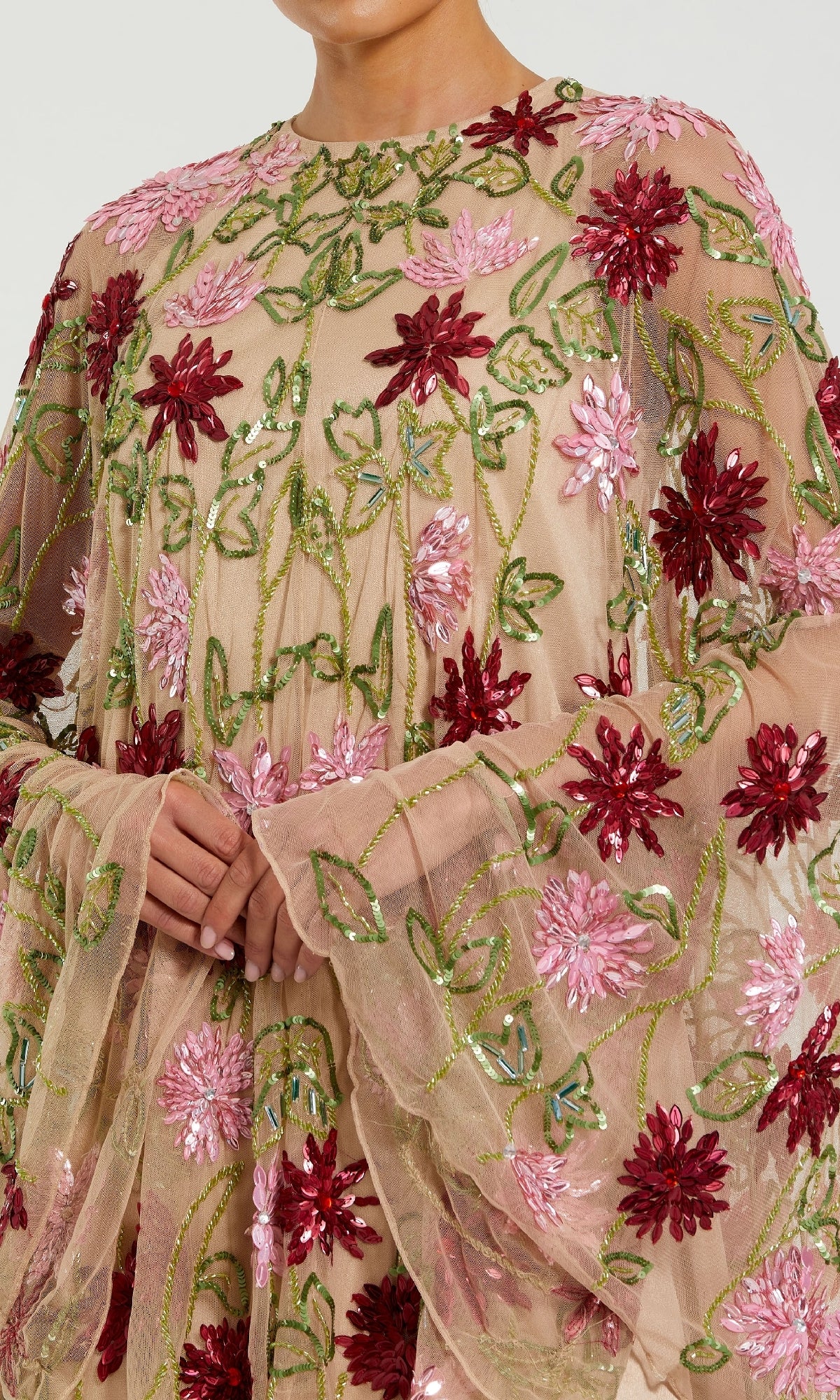 Someone rocks the Sequin Short Wedding Guest Dress: Mac Duggal 6123—a sheer, nude design with pink and red floral embroidery, green leaf details, and sparkling sequin accents—creating a chic party look.