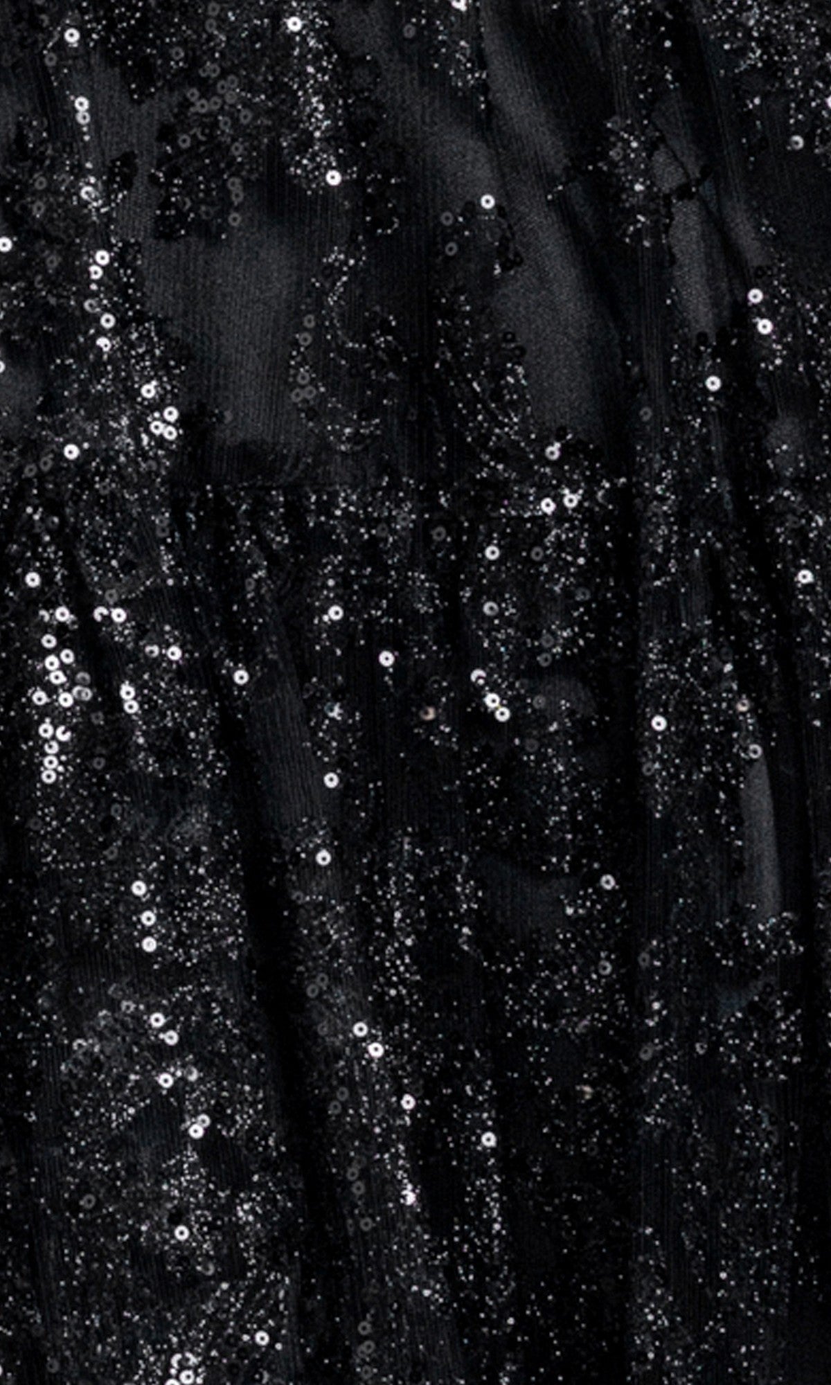 Close-up of black fabric covered in small, shiny sequins creates a sparkly, textured pattern—perfect for the Strapless Mini Hoco Dress: Blondie Nites 6213BN, an ideal choice for a chic short A-line party dress or a standout black sequin homecoming dress.