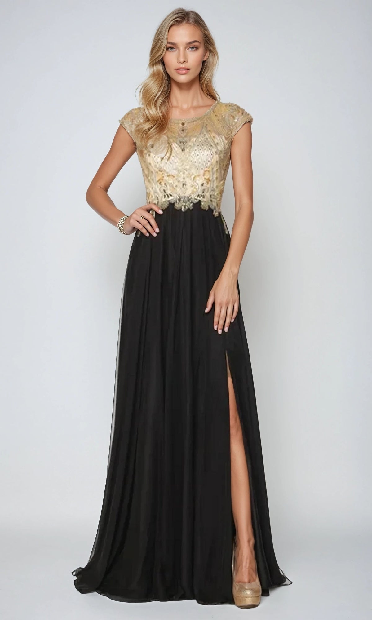 A woman models the Juliet 636 long prom dress, showcasing a gold embellished bodice, sheer back, cap sleeves, A-line skirt with thigh-high slit, and beige heels against a plain background.