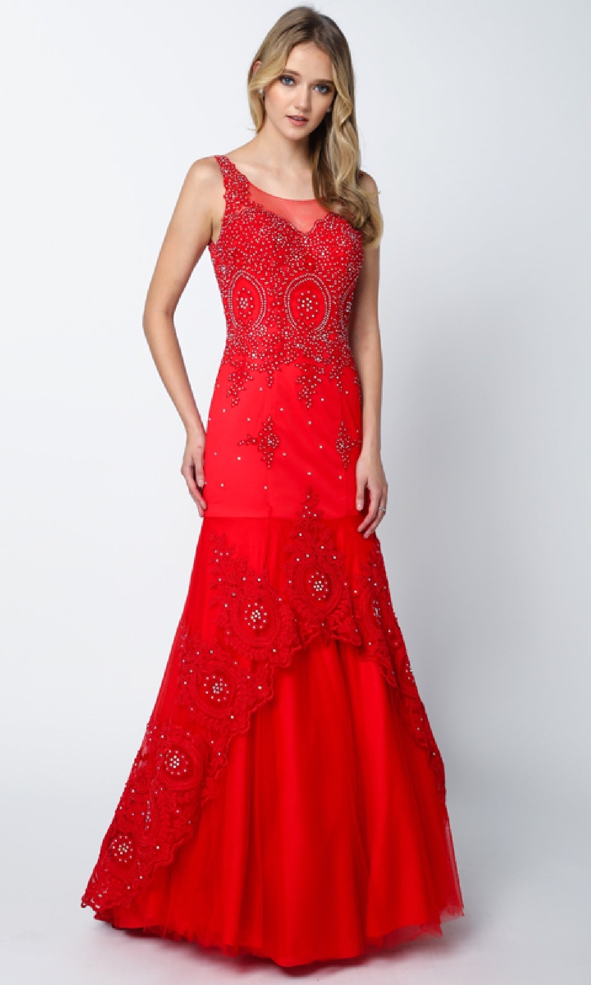 A woman wears the Juliet 654 long prom dress—sleeveless, floor-length, red mermaid style with beaded embellishments and a scoop neckline—standing against a plain white background.