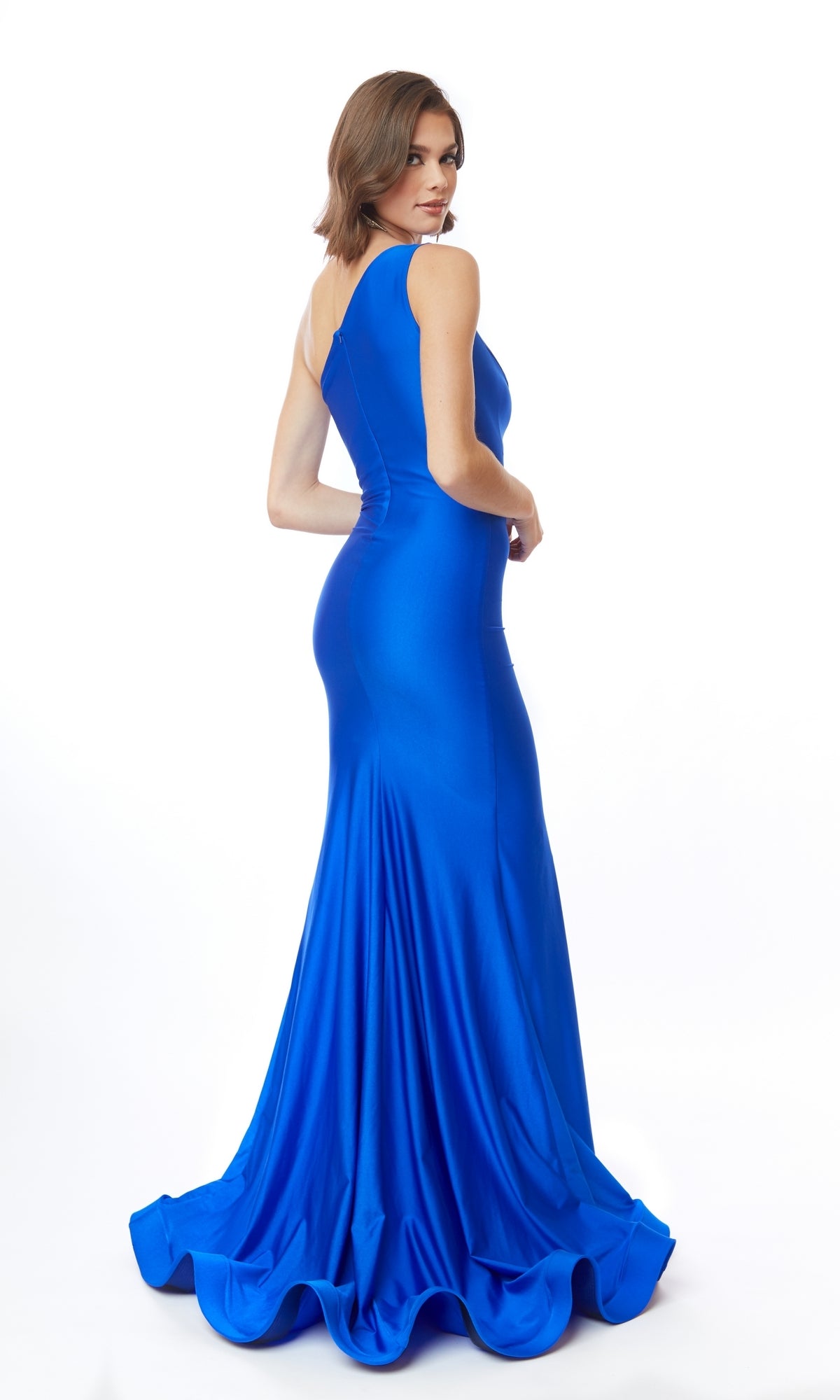 A woman wearing the Atria 6555H One-Shoulder Cut-Out Long Prom Dress stands facing away, head turned toward the camera, against a white background.