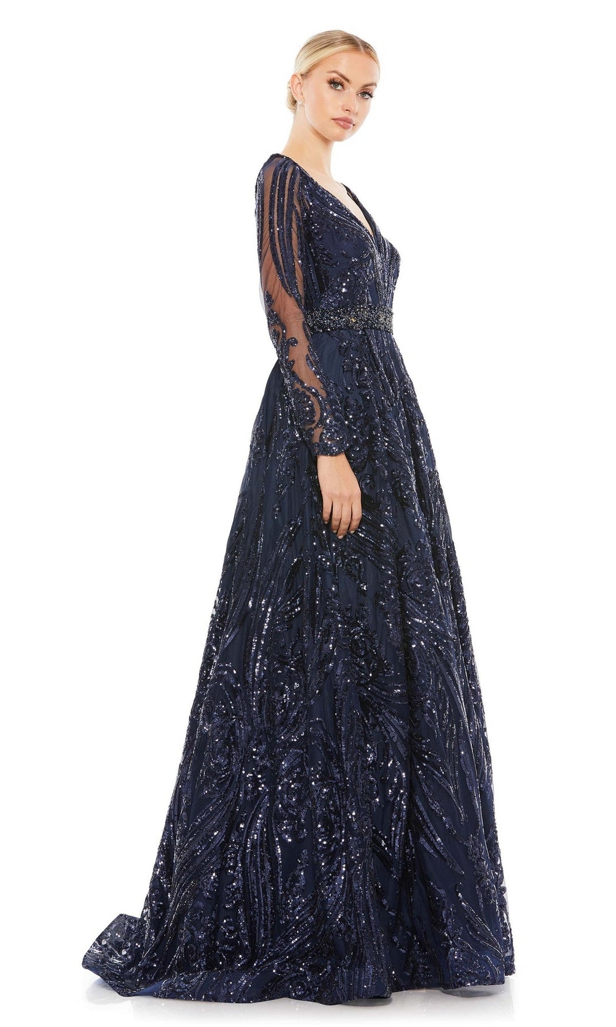 Woman wearing the Long Formal Dress 67113 by Mac Duggal, a floor-length midnight blue gown with long sleeves and sequin accents, posing against a plain white background.