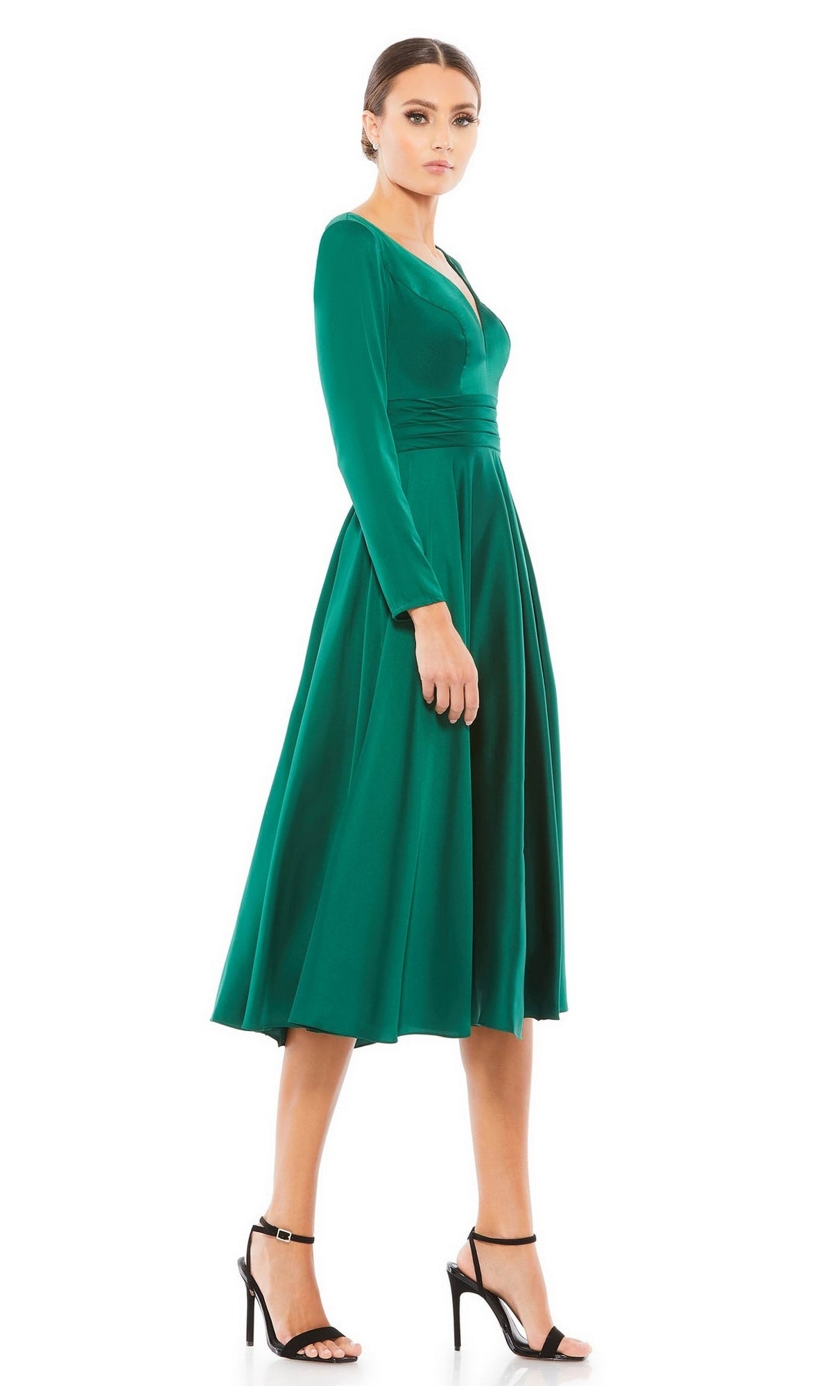Woman wears the Mac Duggal 67527 emerald midi wedding guest dress with long sleeves and a V-neckline, paired with black high-heeled sandals—an elegant choice for any special occasion.