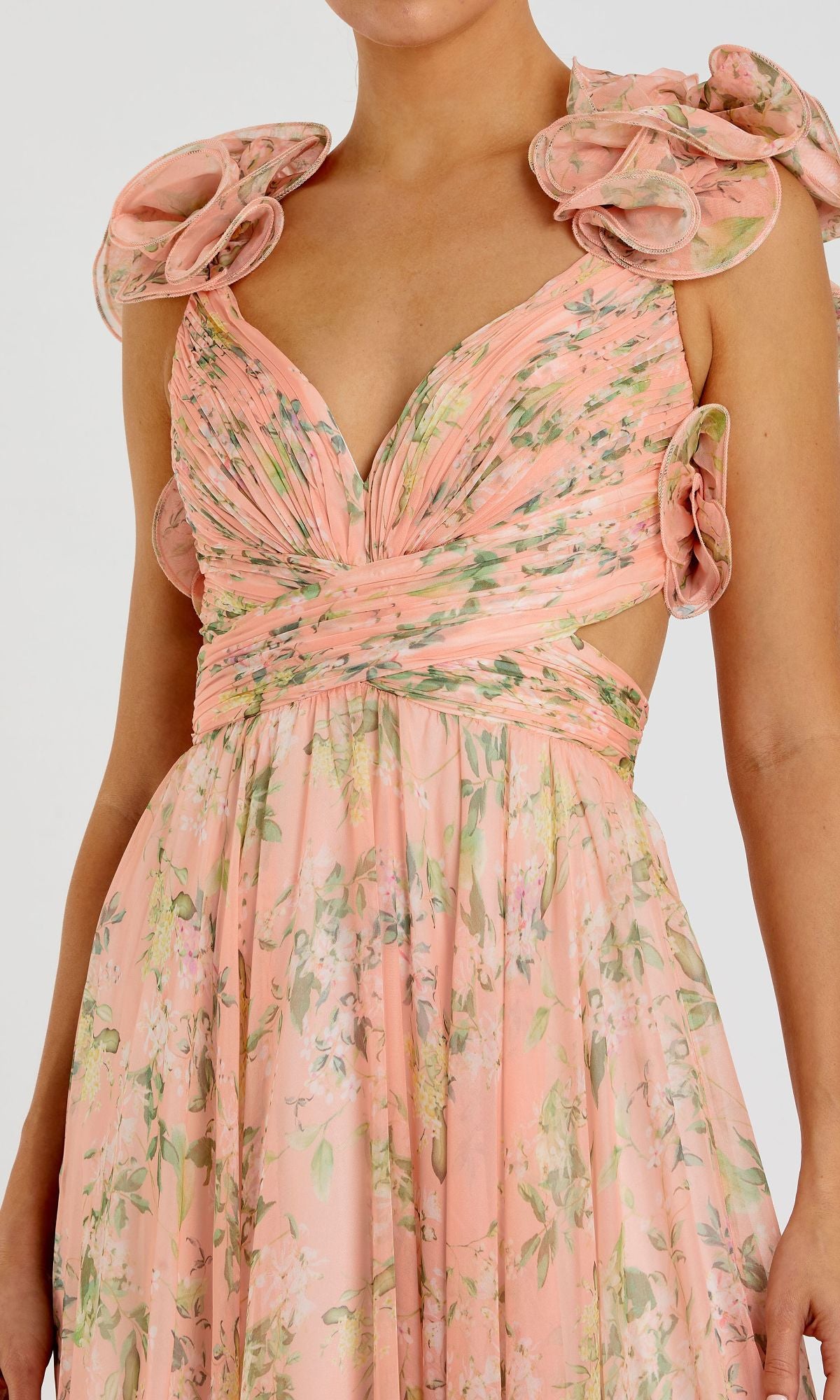 A person wears the Mac Duggal 67803 Ruffled Long Print Formal Dress in pink floral, featuring ruffled shoulder details and a deep V neckline, shown from shoulders to waist.