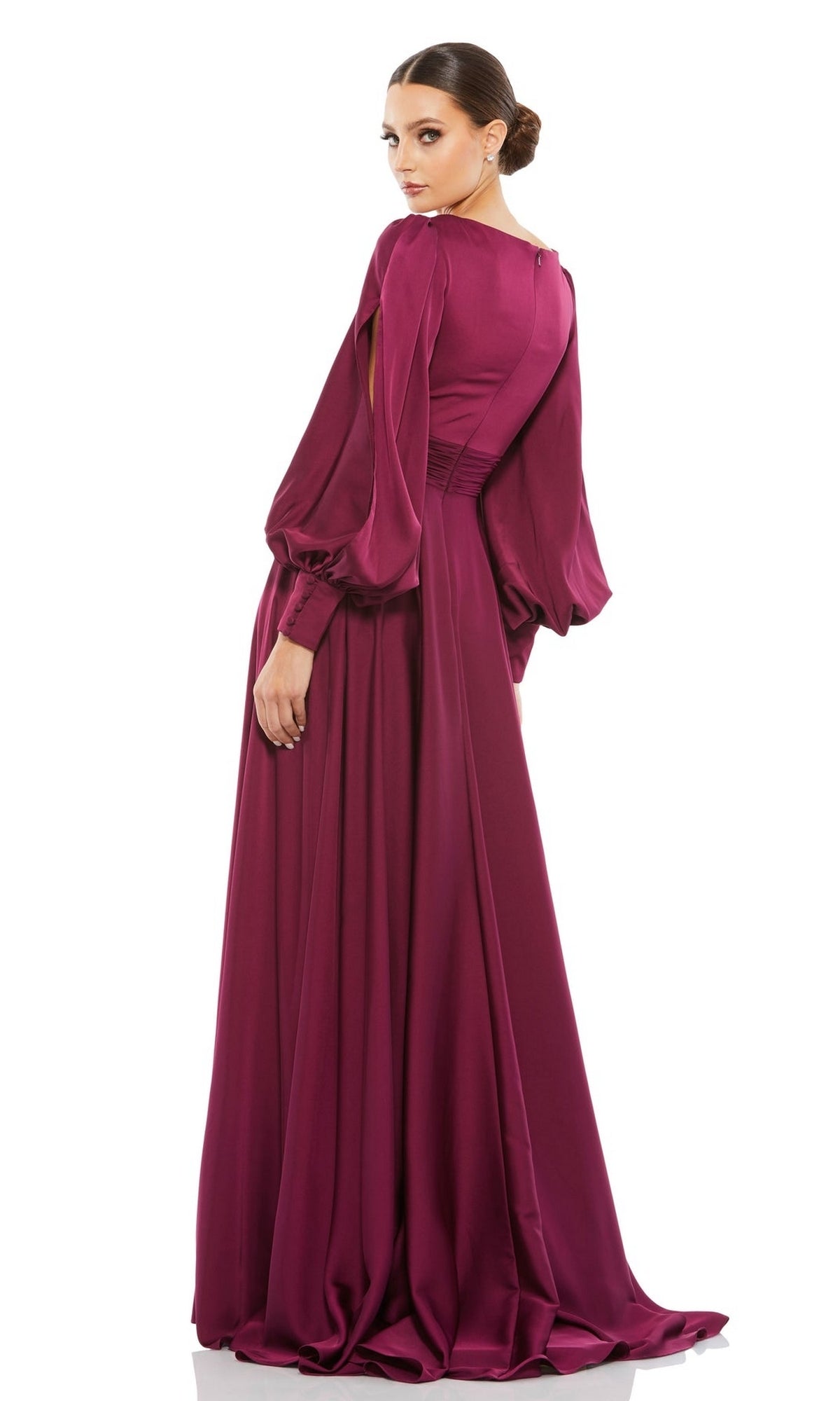A woman models the Long Formal Dress 67847 by Mac Duggal in magenta, featuring flowing split sleeves, as she stands facing backward and looks over her shoulder against a white background.