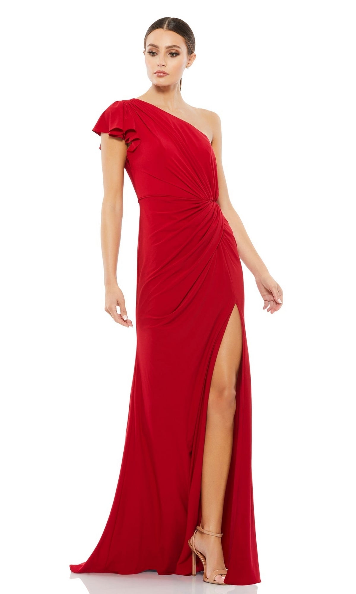 A woman stands in strappy heels, wearing the Mac Duggal Long Formal Dress 67858—a floor-length, one-shoulder gown with a thigh-high side slit.