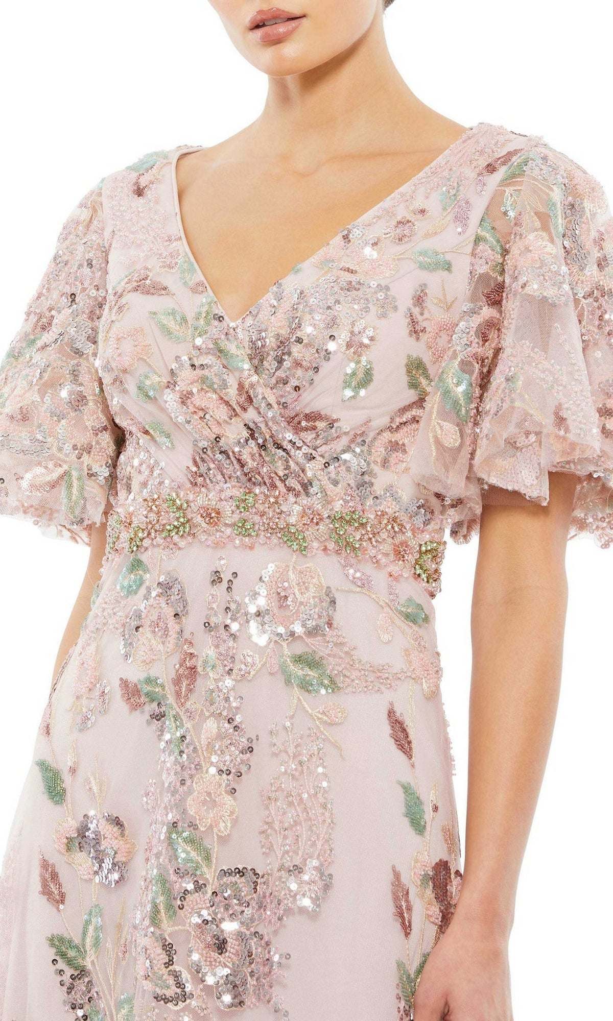 A woman wearing the Mac Duggal 67880 Short Sleeve Pink Formal Dress, featuring floral embroidery, sequins, and short ruffled sleeves.