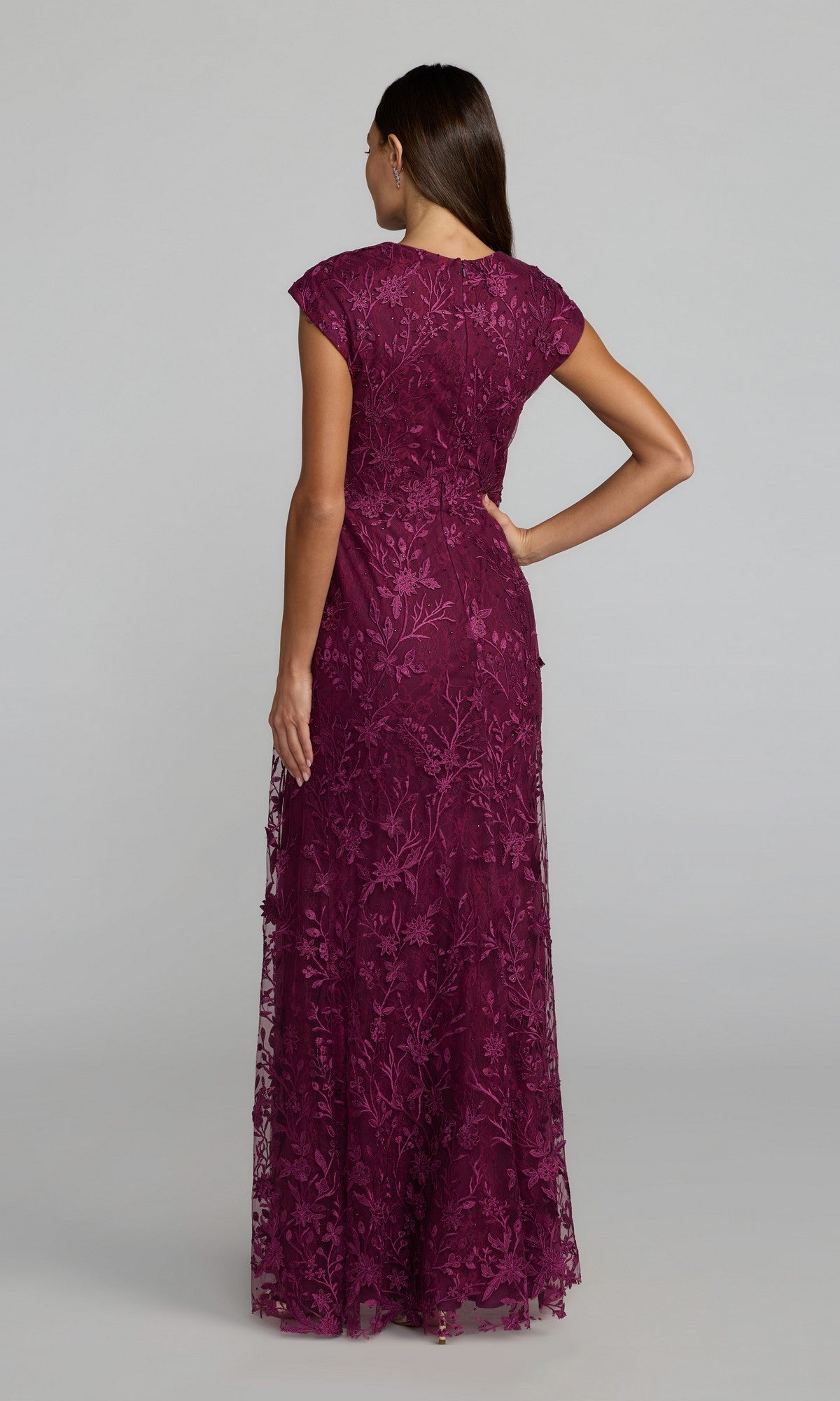 Woman with back to camera wears the Cap Sleeve Long Blue Formal Gown: Mac Duggal 67882—a stunning floor-length blue dress with cap sleeves, perfect for formal occasions.