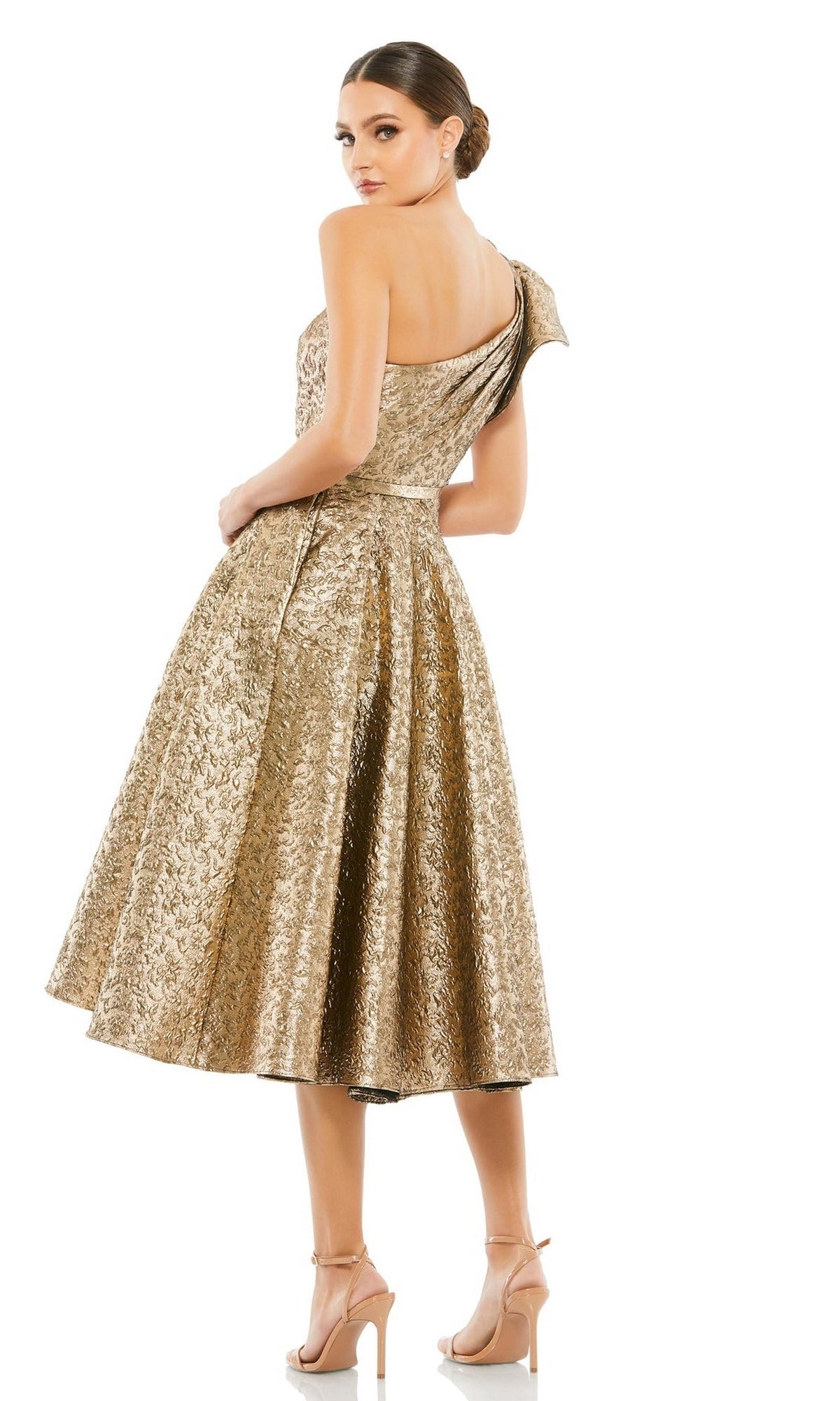 Woman wearing the Mac Duggal 67906 Metallic Short Wedding-Guest Dress—a textured, gold, one-shoulder knee-length dress with a flared skirt and nude heels—stands against a white background, perfect for wedding guests.