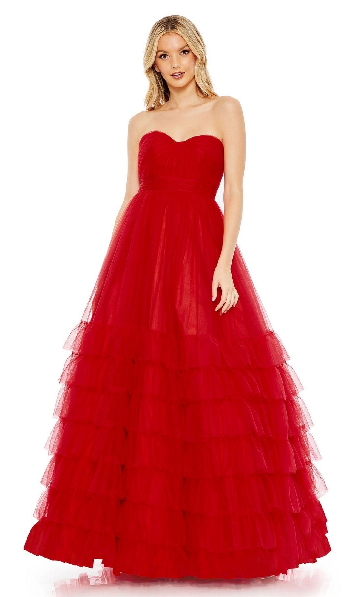A woman wearing the Long Formal Dress 67999 by Mac Duggal, a strapless red ball gown with a fitted bodice and a dramatic, tiered tulle skirt.