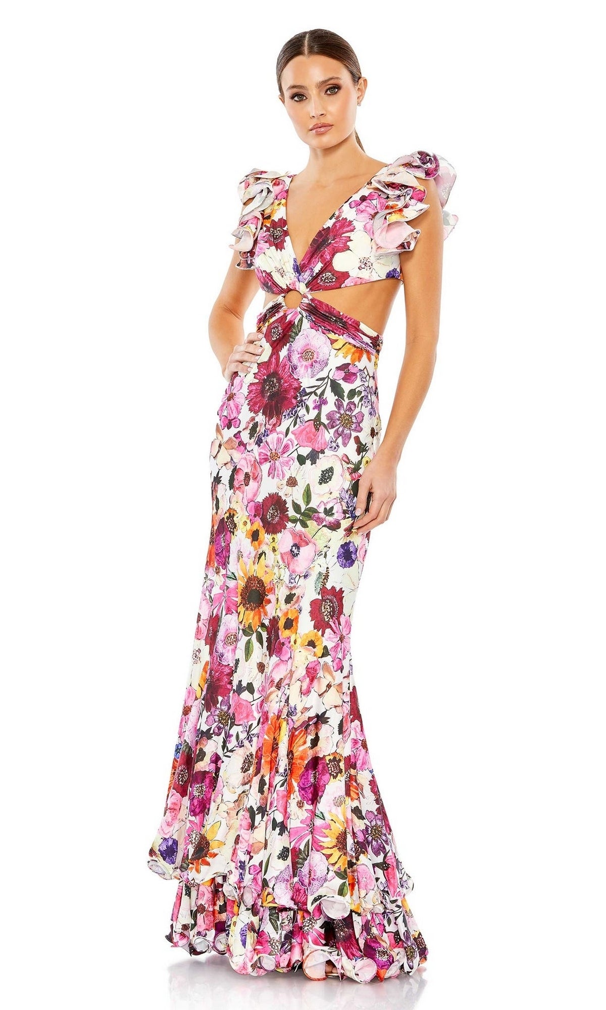 A woman poses in the Mac Duggal 68107 Ruffled Long Print Party Dress, featuring ruffles, a deep V-neck, flutter sleeves, side cutouts, and a floral print against a plain white background.