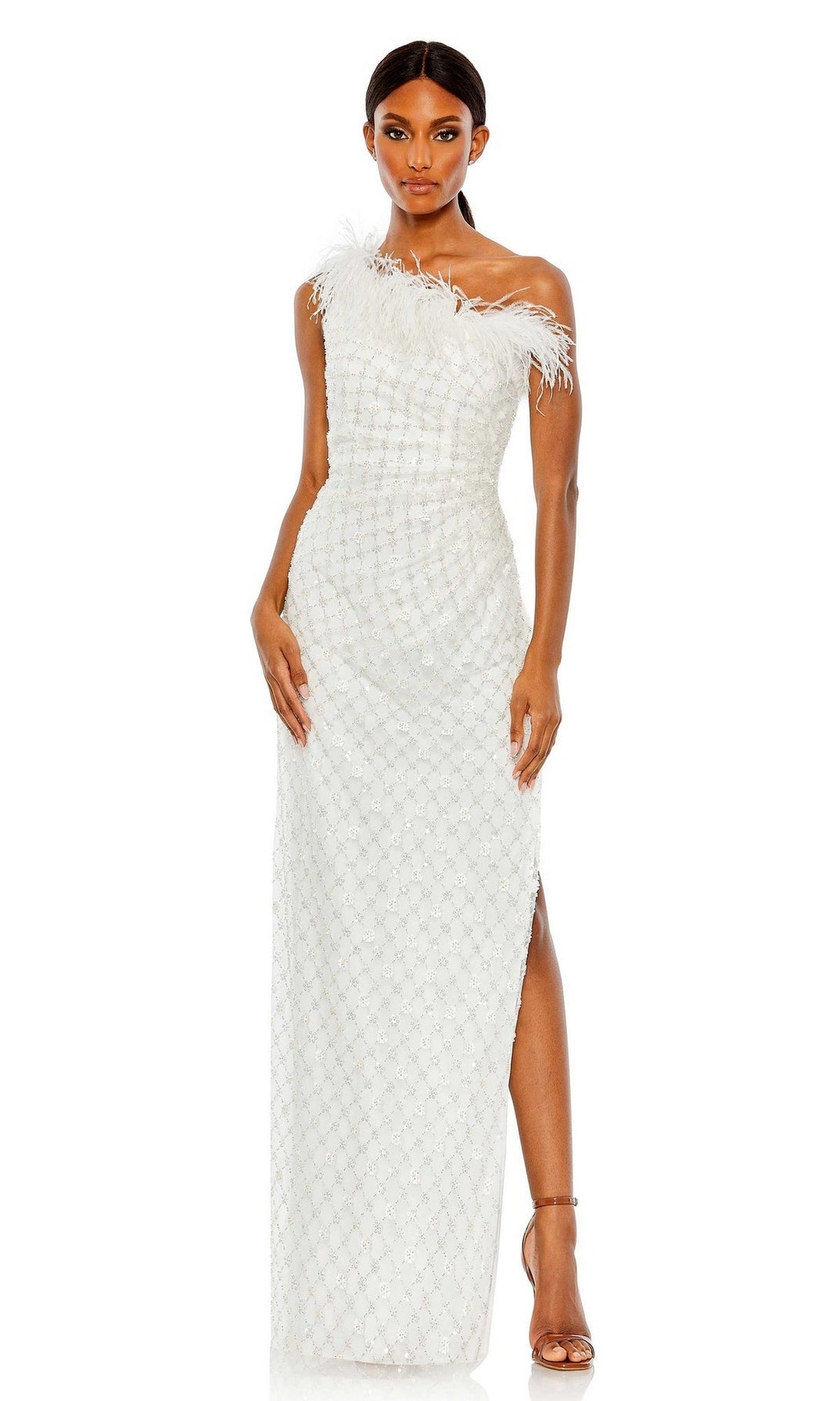 A woman wears the Feather One-Shoulder Formal Gown: Mac Duggal 68139, a floor-length dress with a textured pattern and feather neckline, styled with strappy heels and long dark hair.