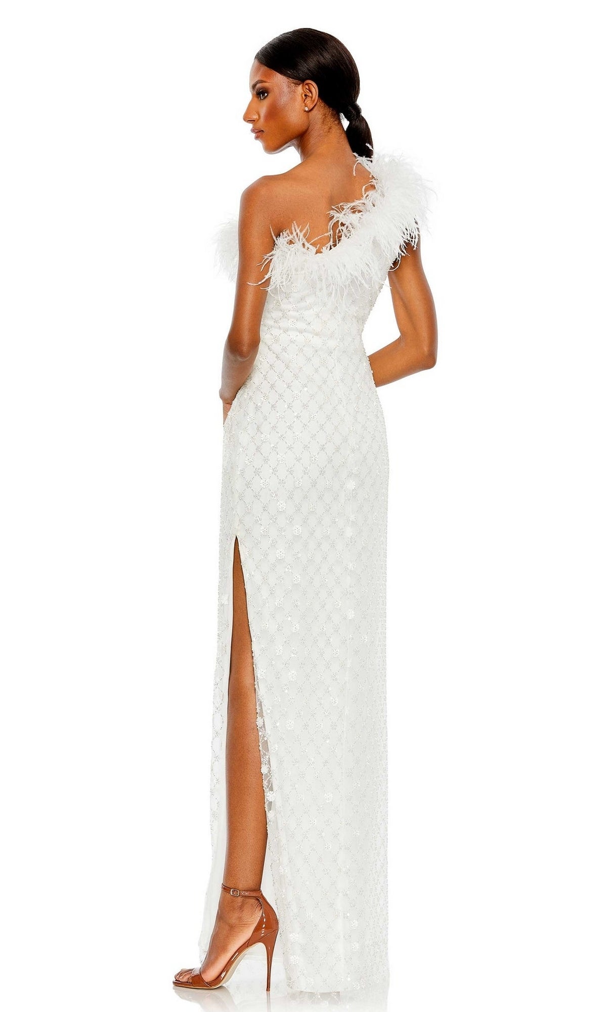 A woman in profile with her hair tied back wears the Mac Duggal 68139 Feather One-Shoulder Formal Gown—white, floor-length, featuring feather detailing and a side slit.