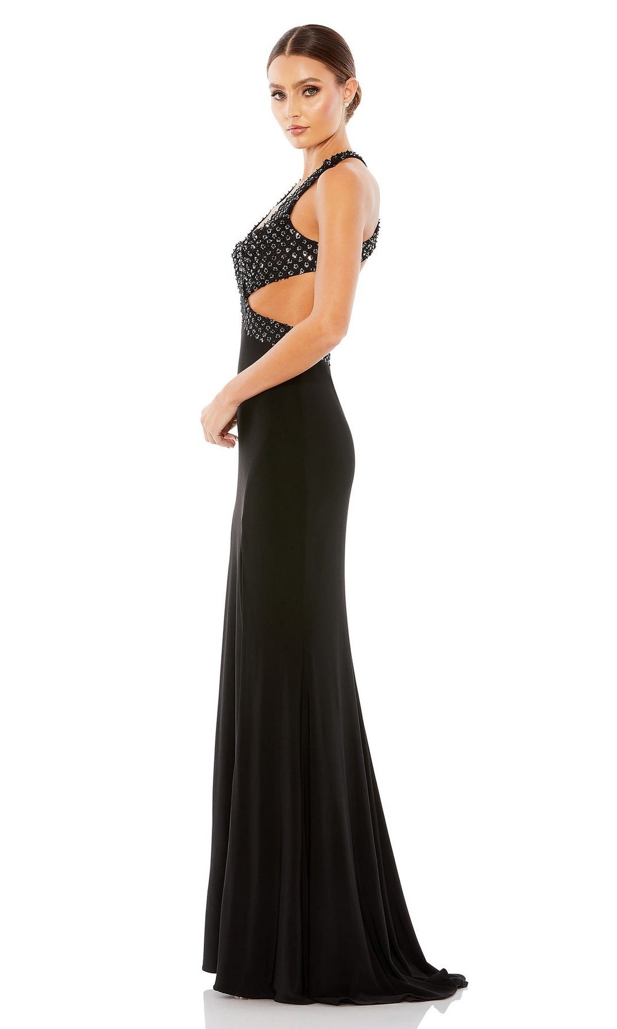 Woman standing sideways in the Mac Duggal Long Formal Dress 68166—a black sleeveless gown with beaded detail, v-neckline, side cutouts, and open back—posed against a plain white background.
