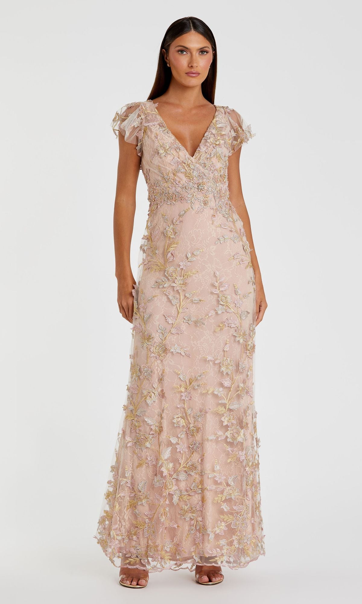 A woman stands wearing the Mac Duggal 68192 Long Beaded Formal Dress, a blush pink evening gown with short flutter sleeves, floral embroidery, and a V-neckline.
