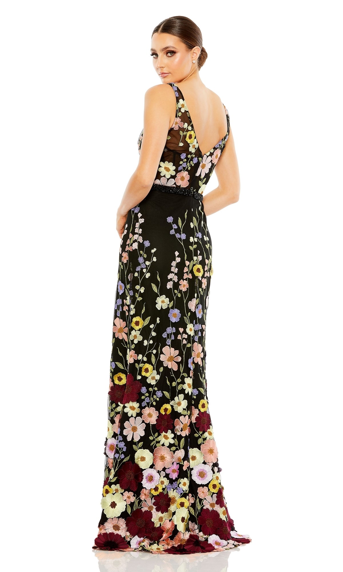 Woman in the Mac Duggal 68200 Floral Long Black Formal Dress stands looking over her shoulder against a white background.