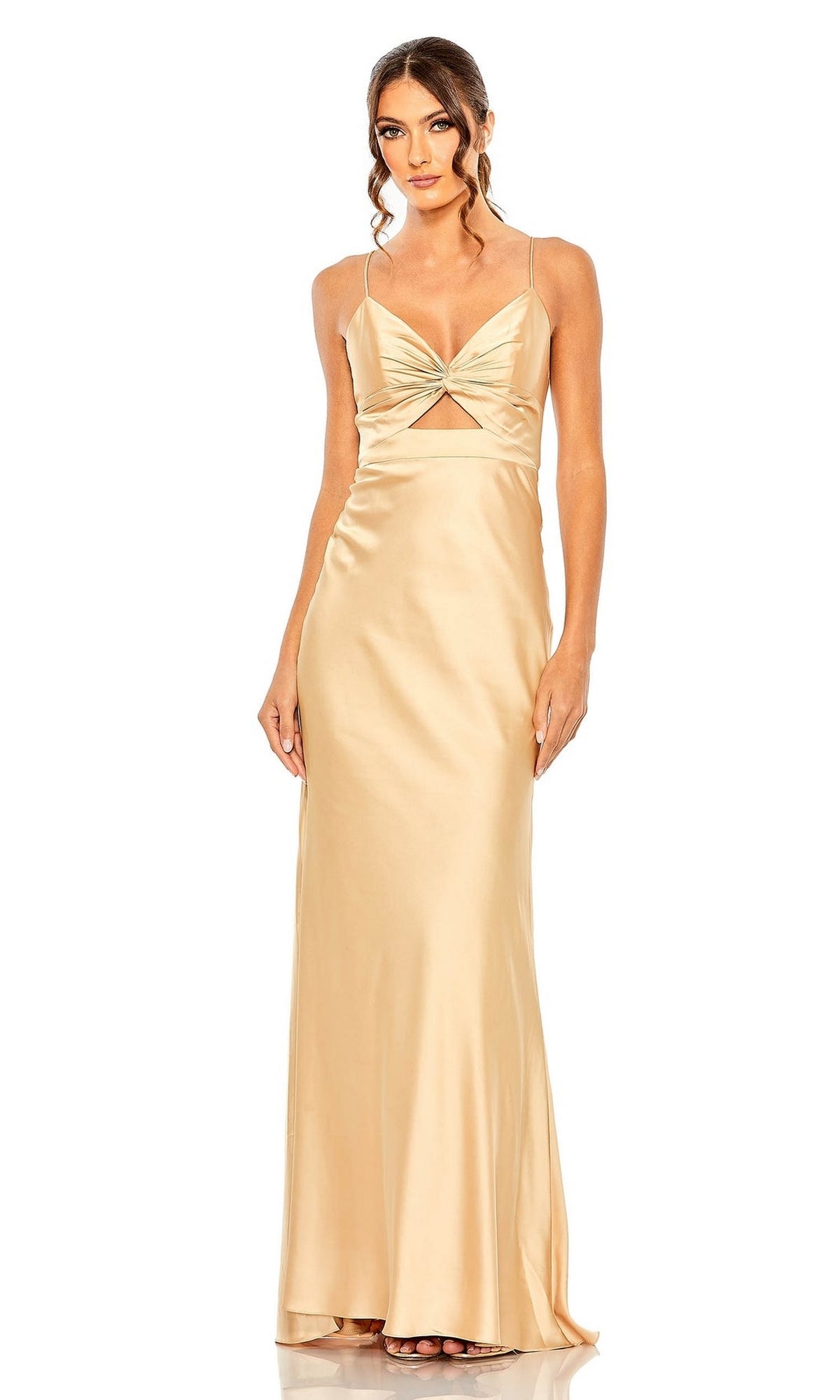 A woman models the Mac Duggal 68347 Cut-Out Long Formal Dress, showcasing champagne satin, spaghetti straps, a twist-front bodice with a front cutout, and a fitted silhouette against a white backdrop.