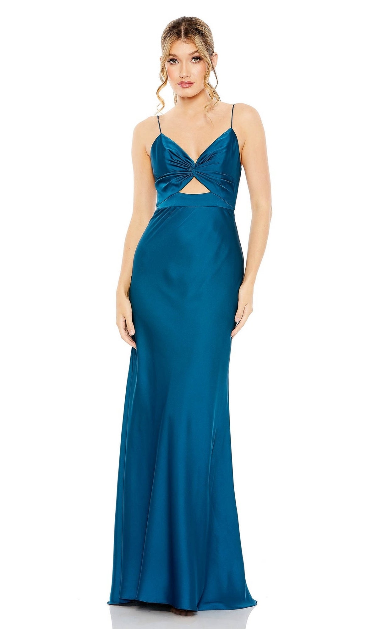 A woman stands against a white background wearing the Mac Duggal 68347 Cut-Out Long Formal Dress—teal satin with spaghetti straps, twist-front bodice, front cutout below the bust, and a floor-length skirt.