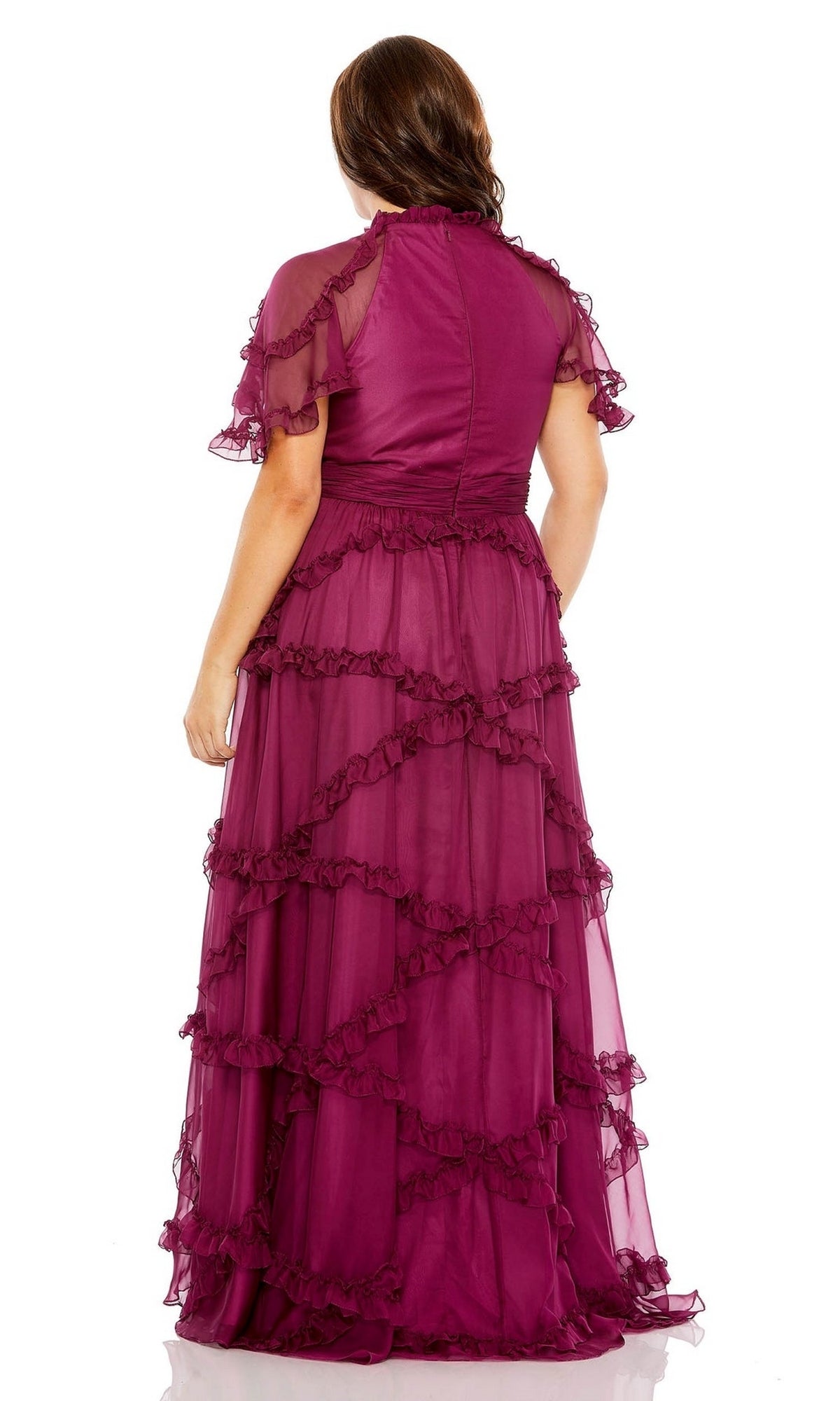 A woman faces away, wearing the Long Plus-Size Prom Dress 68424 by Mac Duggal—a floor-length magenta ruffle tiered dress with sheer fabric, short sleeves, and an elegant A-line silhouette.