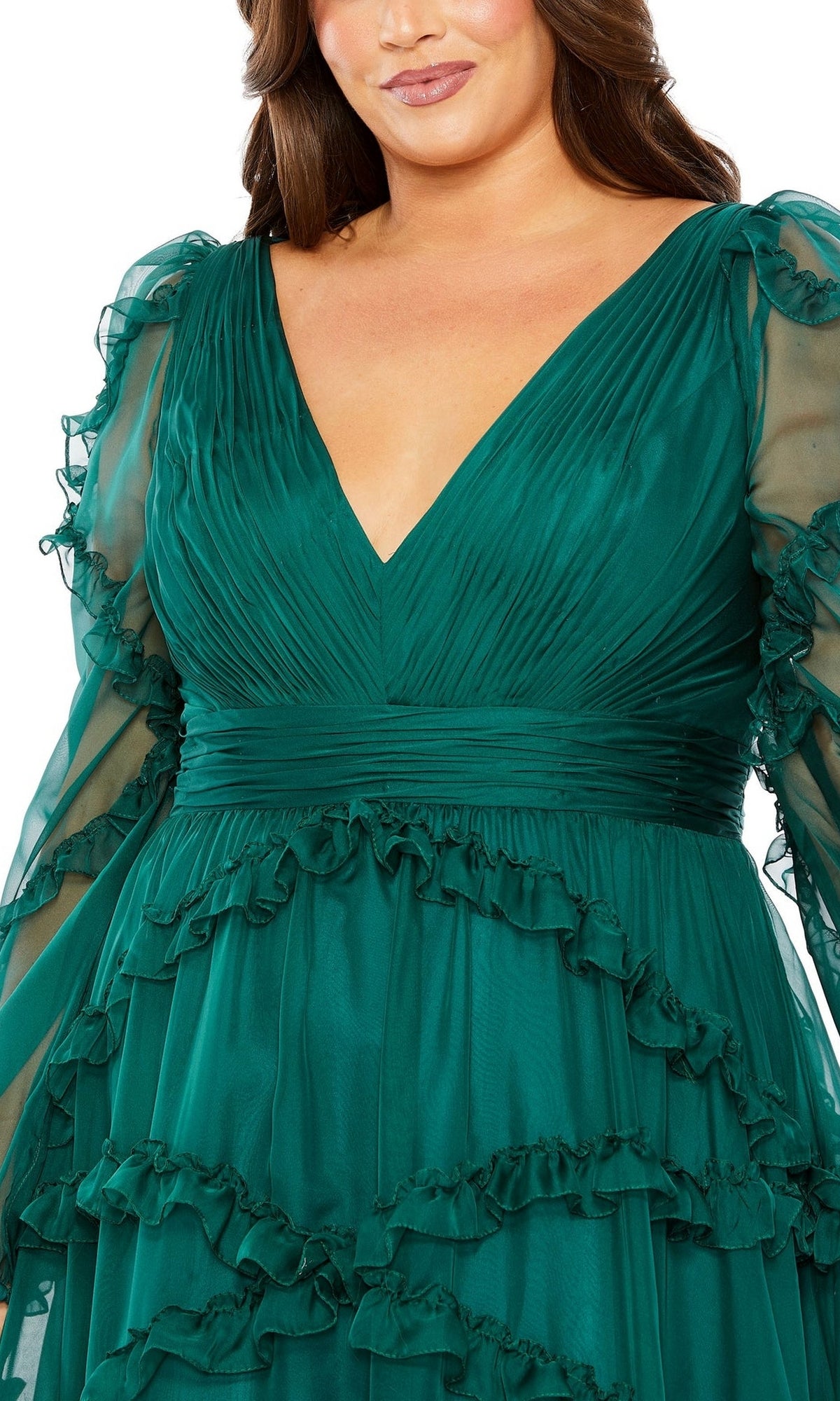 Woman wearing the Long Plus-Size Prom Dress 68425 by Mac Duggal in deep green, featuring a V-neckline, sheer long sleeves, and ruffle details on the bodice and skirt.