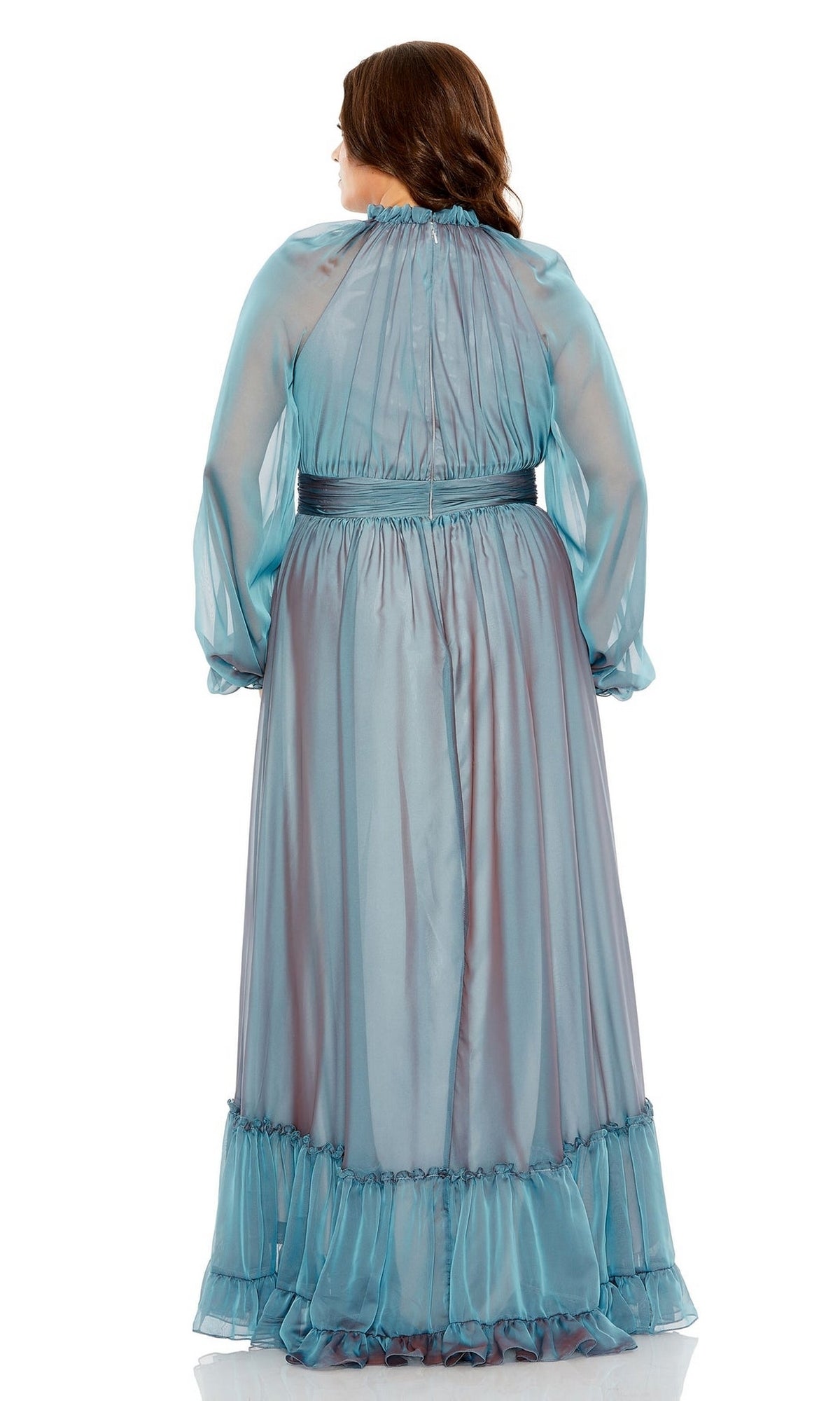 A woman is standing with her back to the camera, wearing the Long Plus-Size Prom Dress 68434 by Mac Duggal— a light blue, long-sleeved gown with a floor-length ruffle hem.