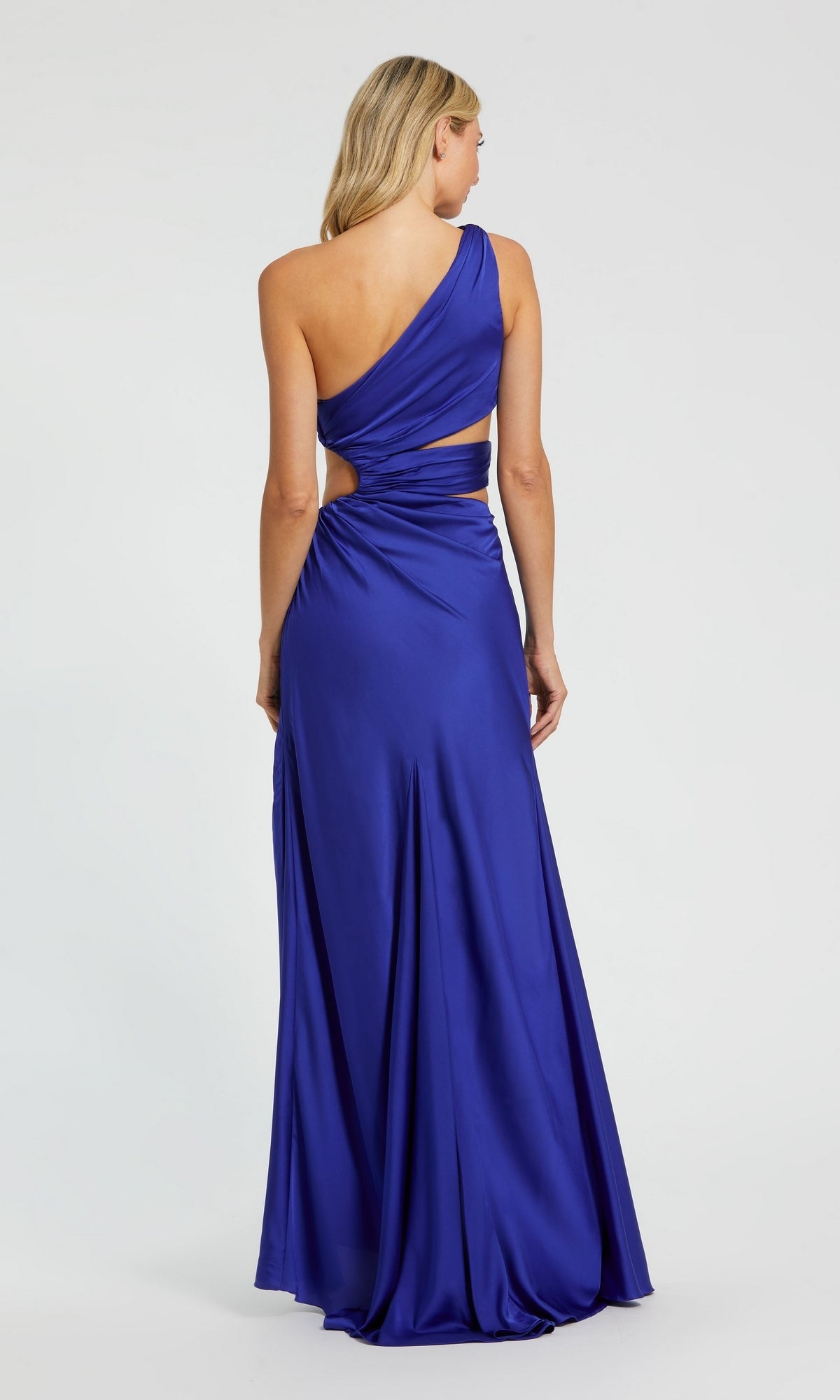 A woman is seen from the back wearing the Mac Duggal 68485 One-Shoulder Cut-Out Formal Gown in royal blue.