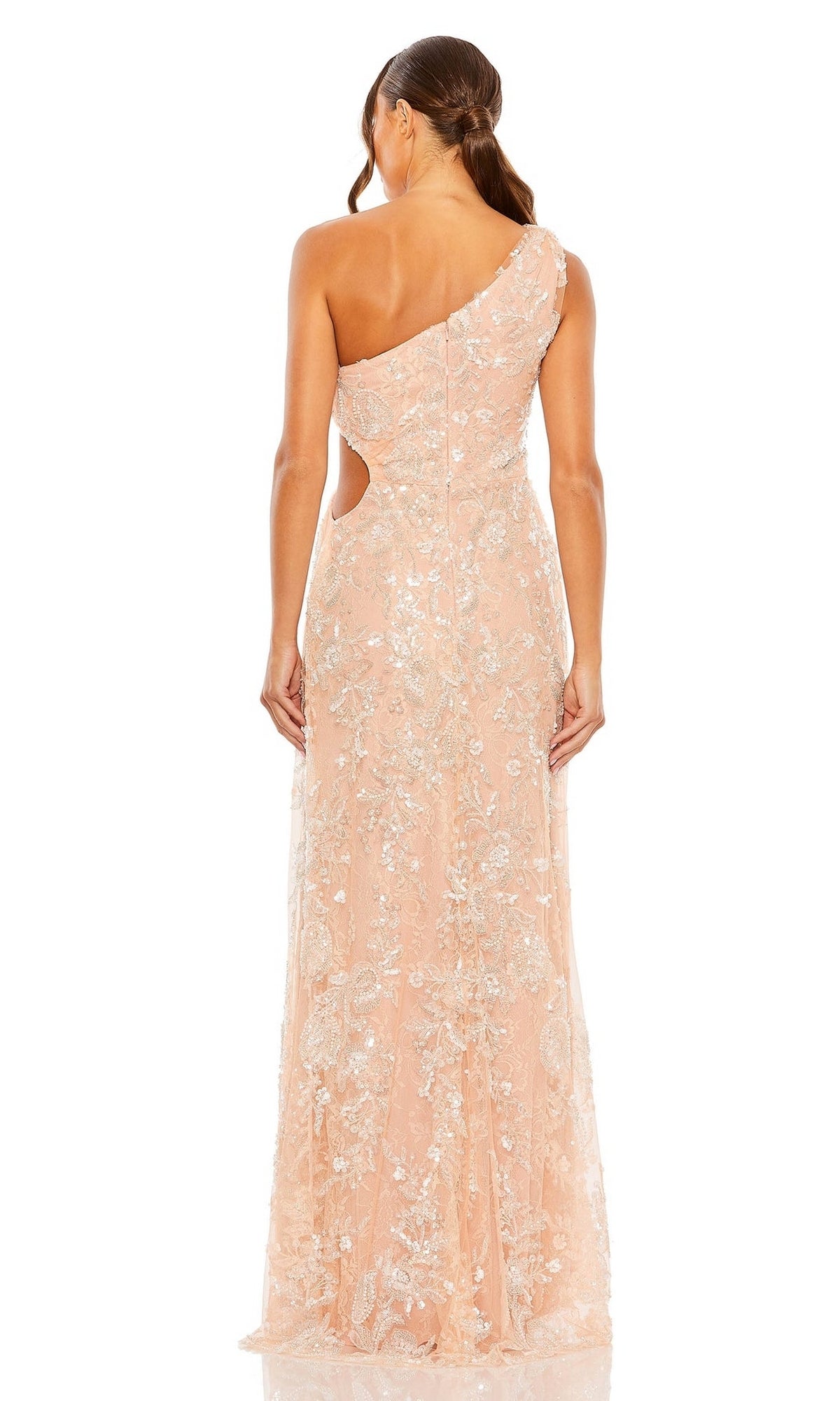 A woman elegantly shown from the back wears the Long Formal Dress 68507 by Mac Duggal: a peach, one-shoulder gown featuring silver floral embroidery, side cutouts, and a gathered long skirt.