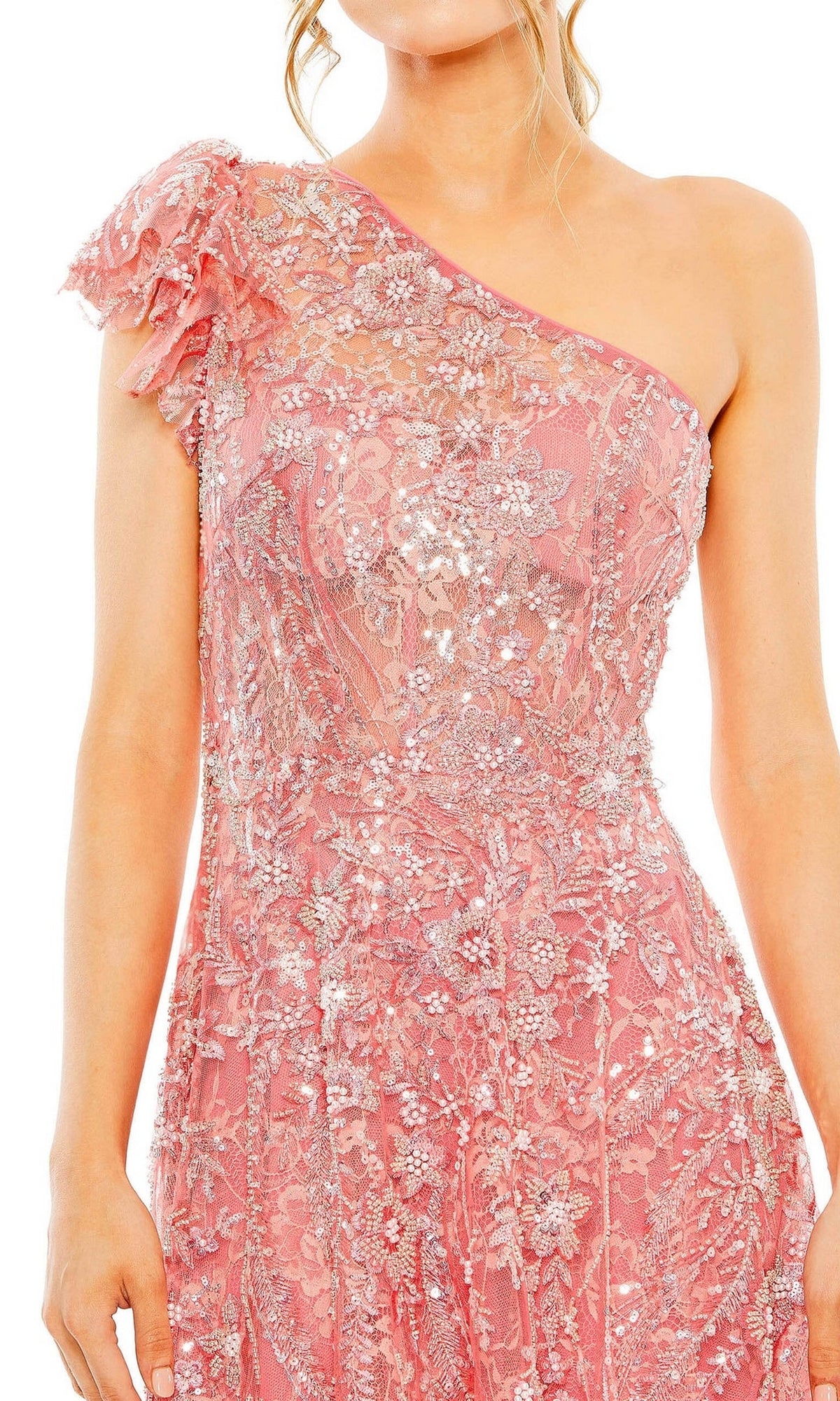 A woman wears the Long Formal Dress 68512 by Mac Duggal, a coral pink one-shoulder gown with floral lace and sequin embellishments, shown from shoulders to mid-thigh.